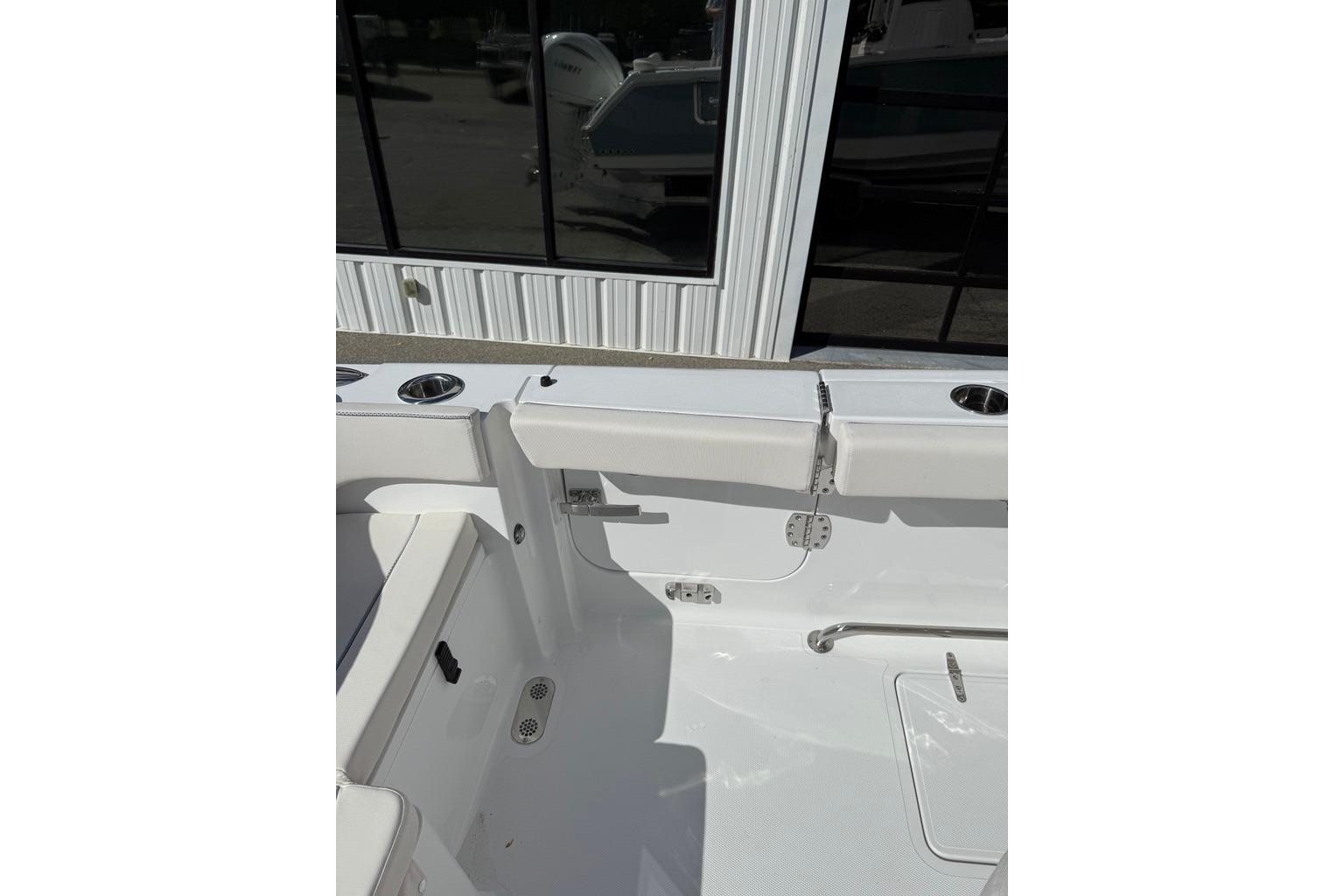 2026 Sea Hunt Ultra 285 Coffin Box boat interior with white seating and cup holders.