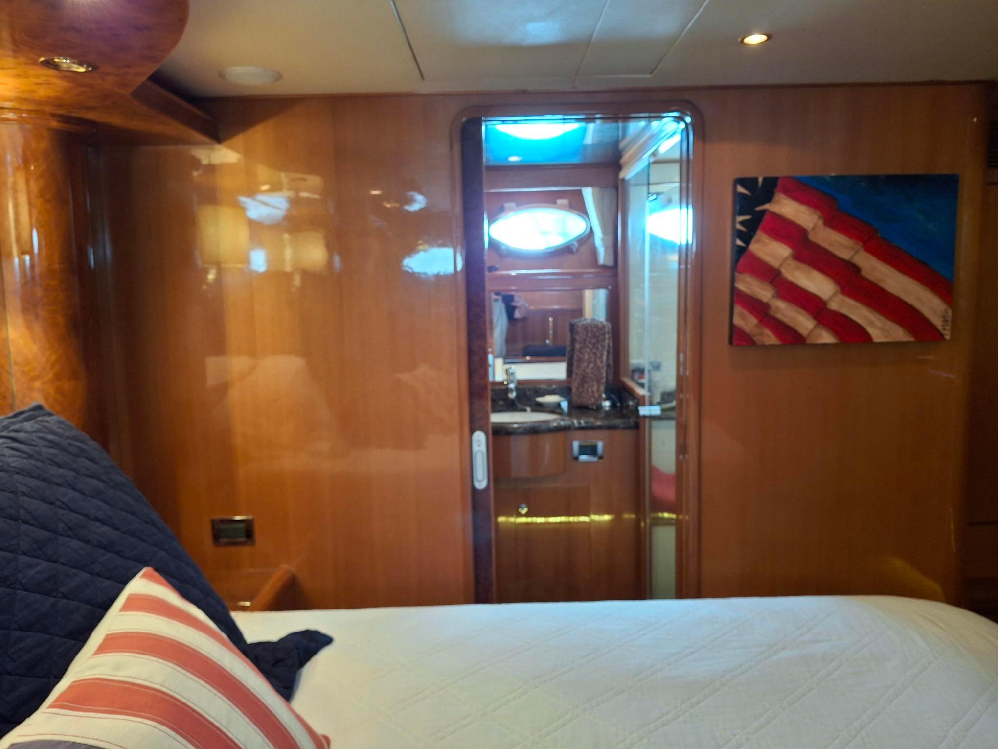 Luxurious cabin interior of 2004 Ocean Alexander 64 Pilothouse yacht with wooden finish.