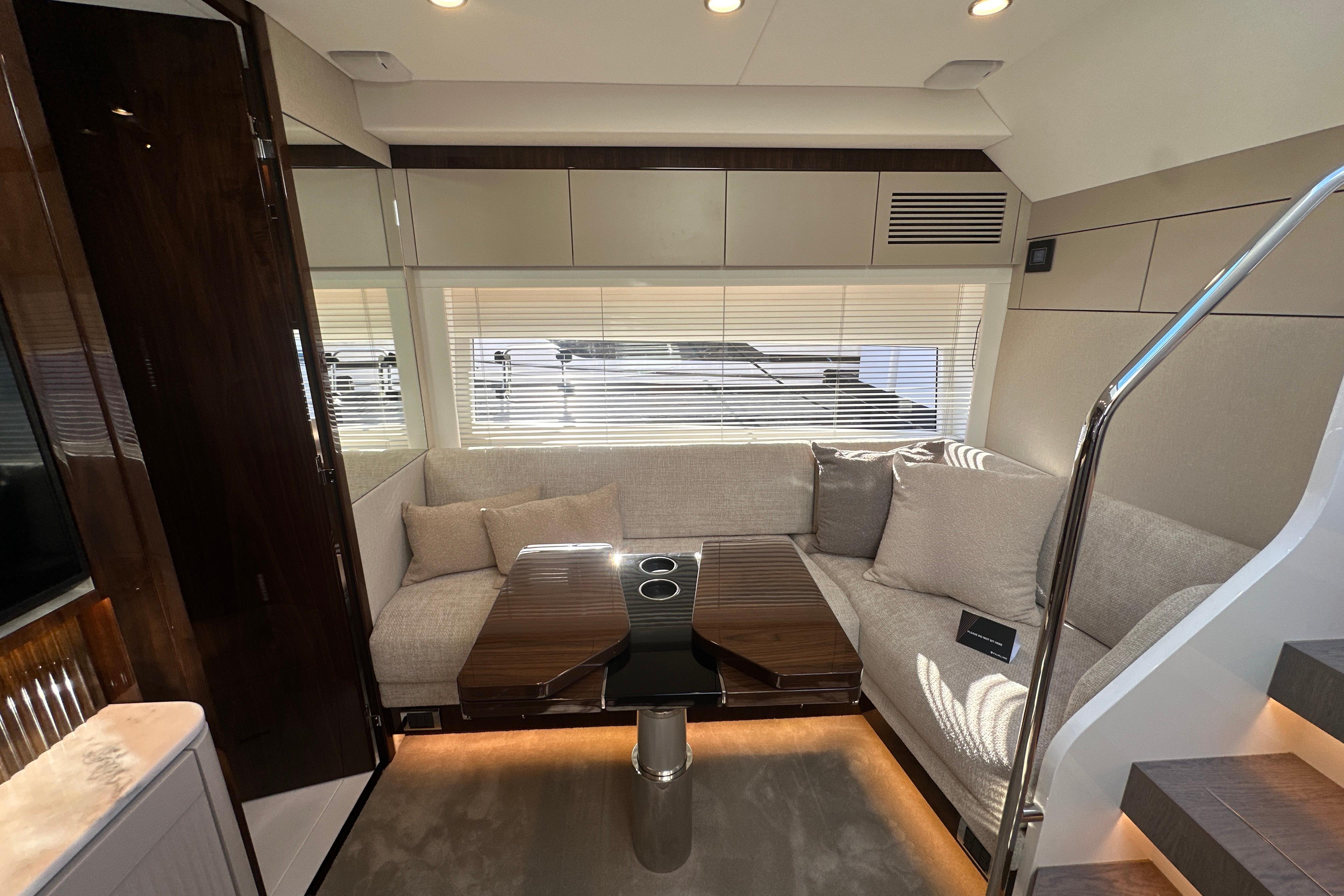 Luxurious interior of 2026 Fairline Targa 47 GT yacht with modern seating and table.
