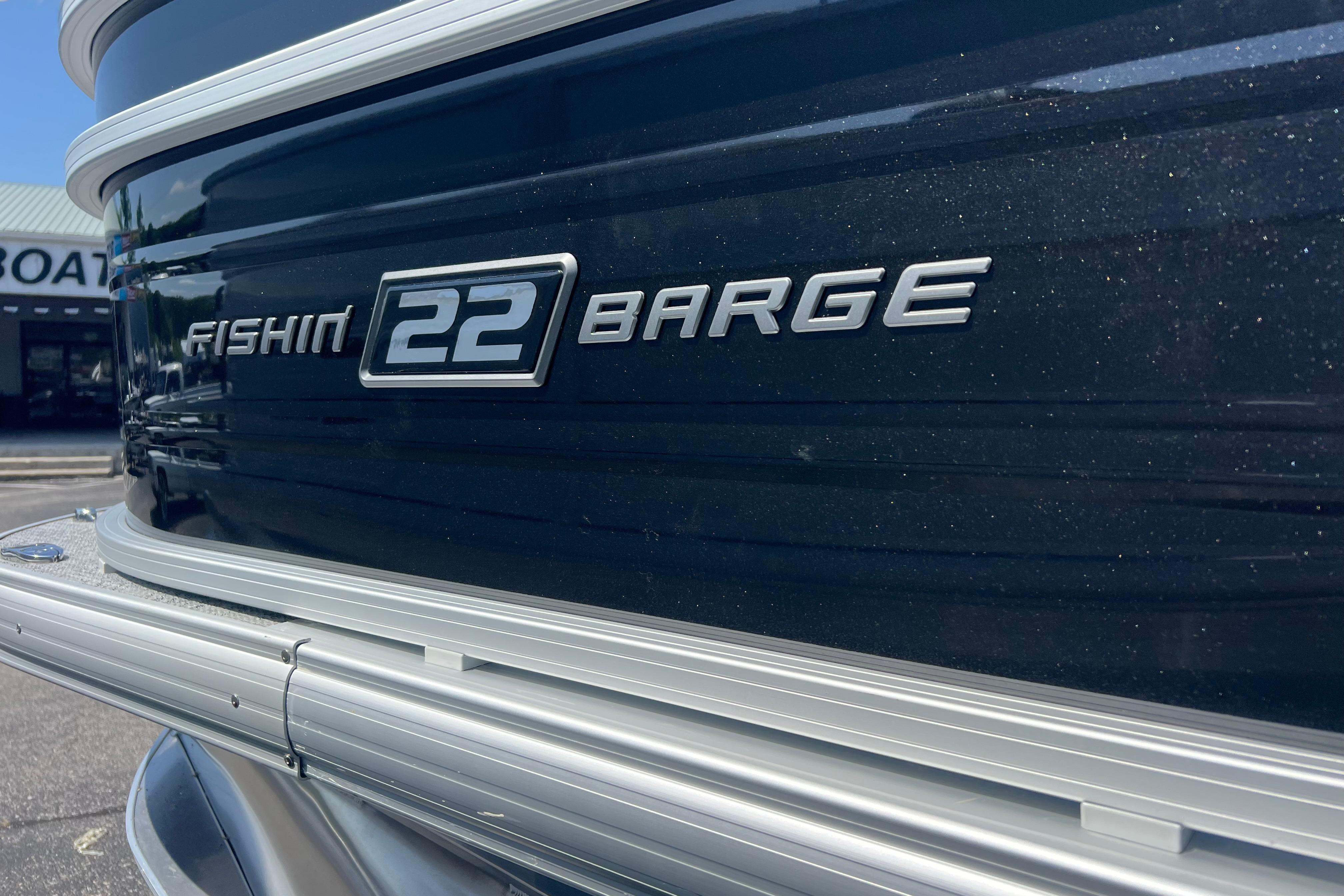 2026 Sun Tracker Fishin' Barge 22 DLX boat exterior with model nameplate.