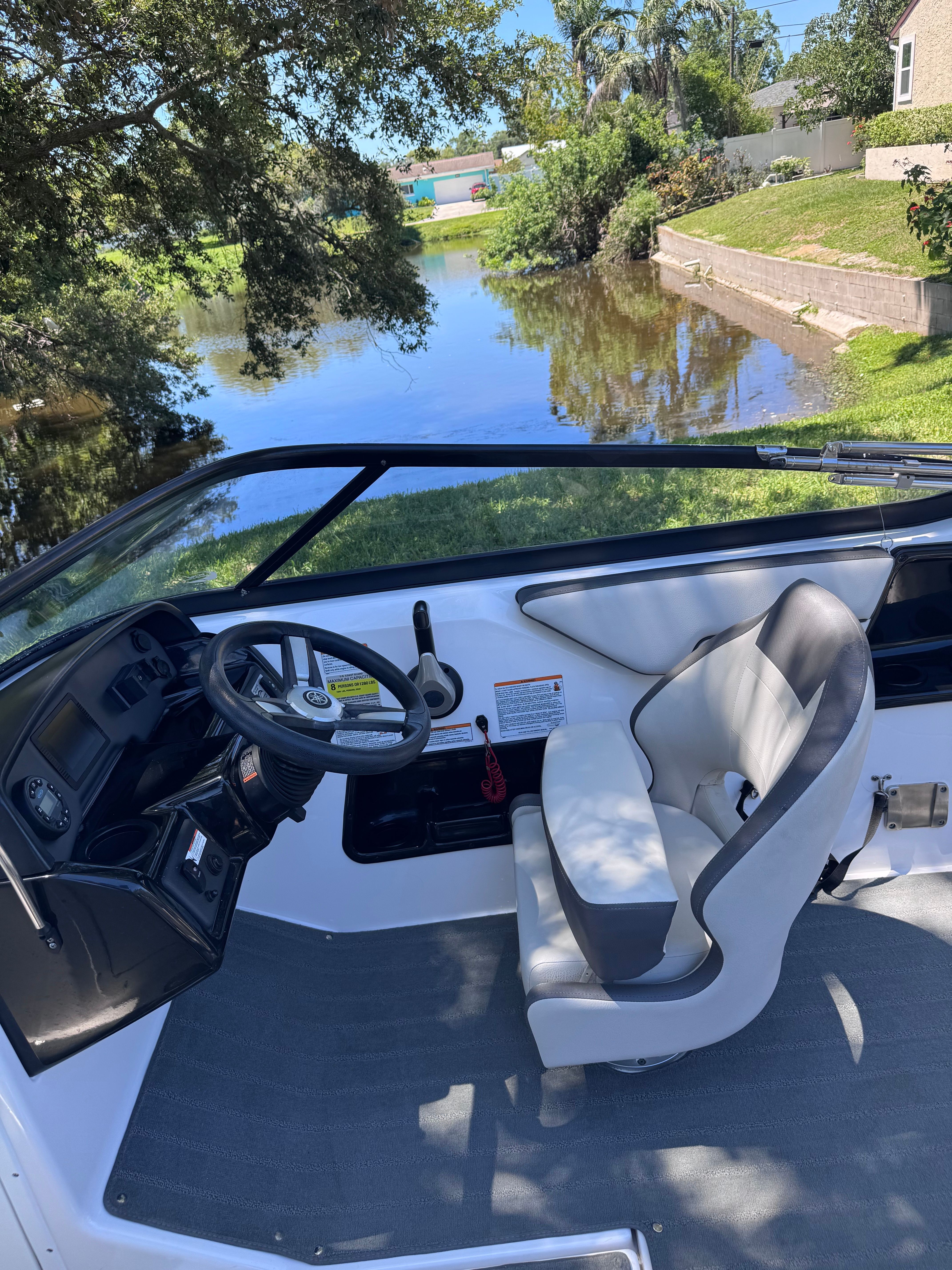 Interior of a 2020 Yamaha SX190 boat by the riverside.