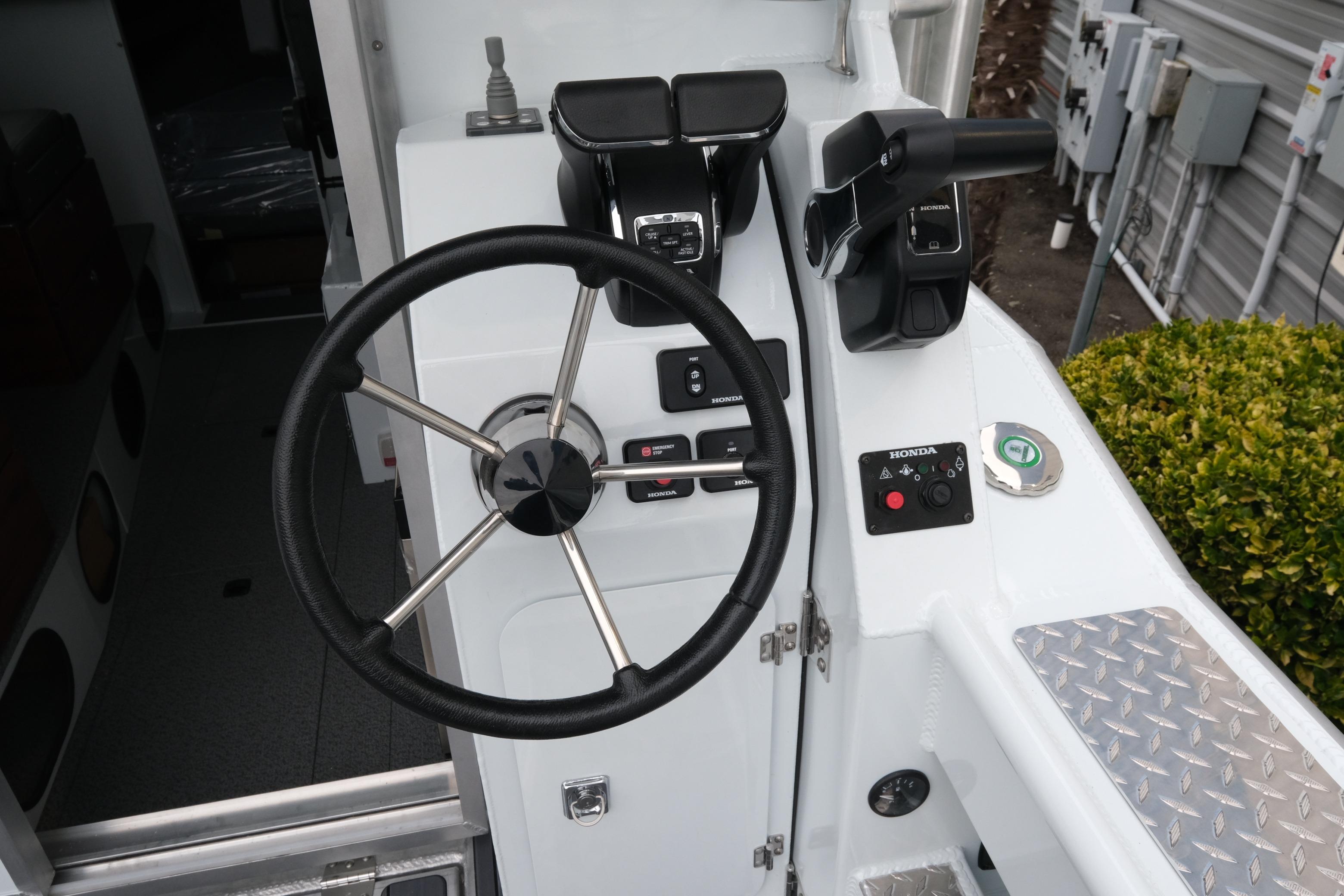 Steering console of 2026 Hewescraft 270 Pacific Explorer with Honda controls.