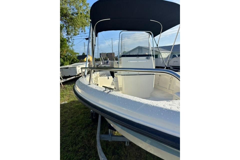 2005 Hydra-Sports Lightning 180 CC boat with canopy, parked on grass.