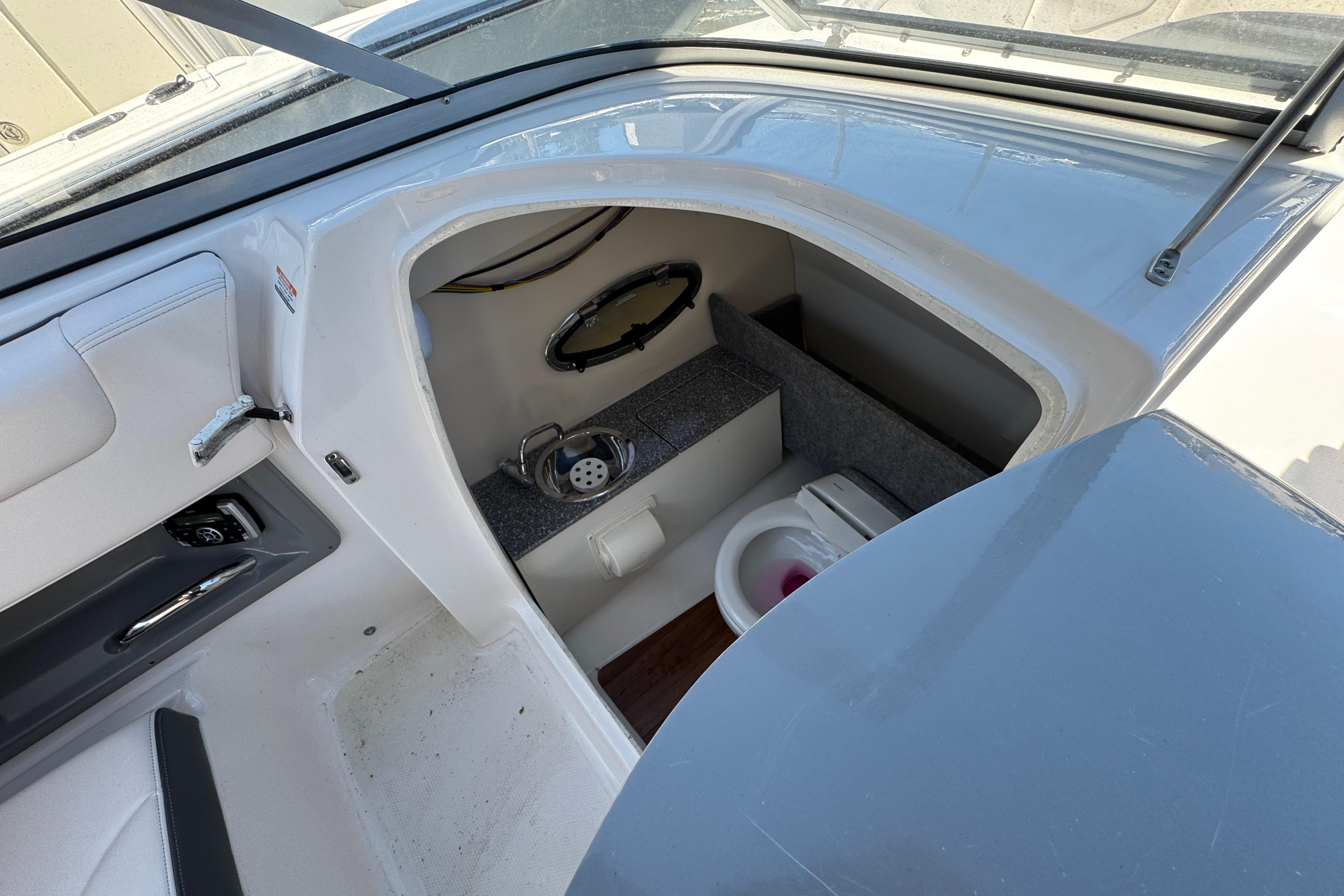 2018 Chaparral 250 Suncoast boat interior with compact bathroom amenities.