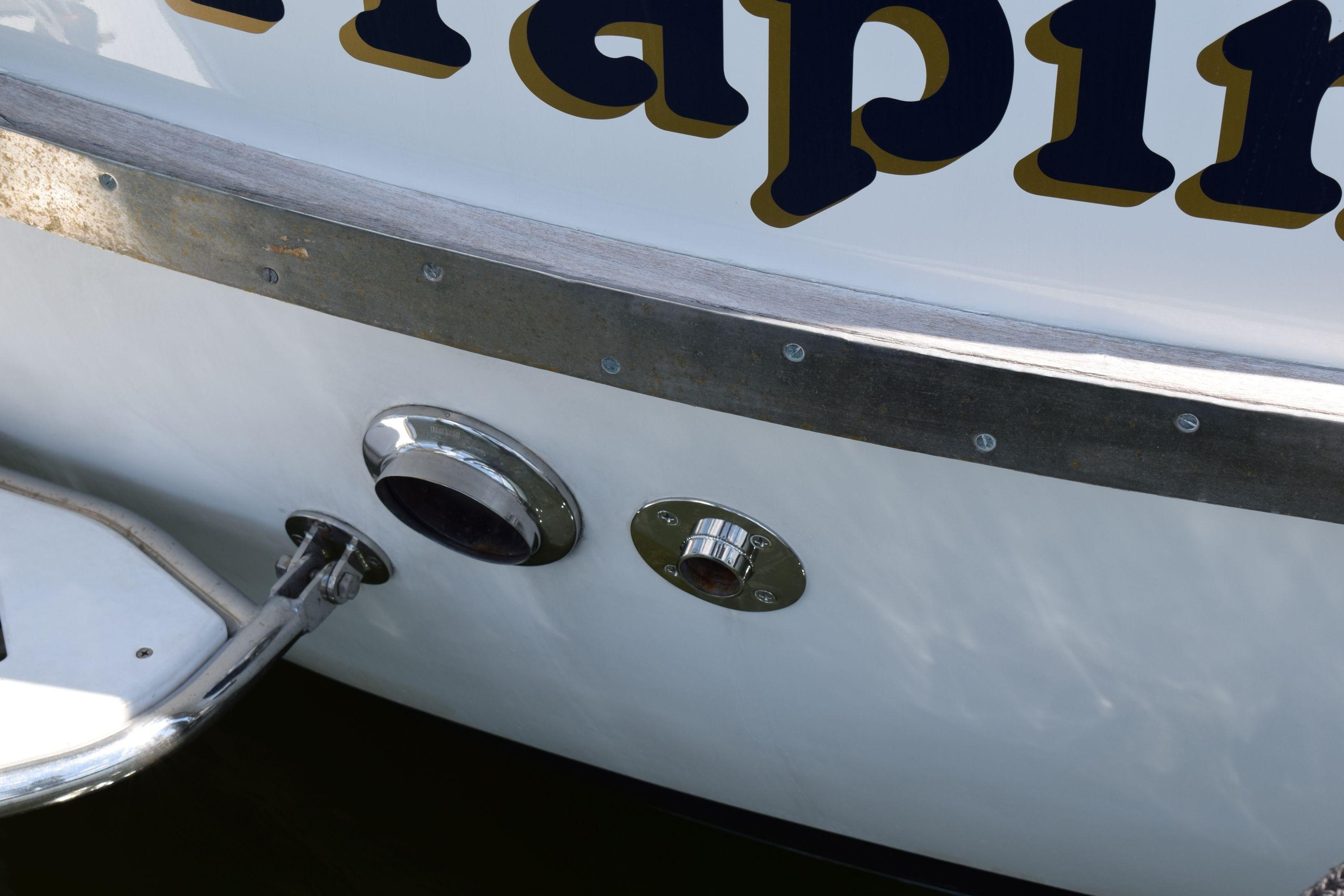 1980 Cheoy Lee 52 Motorsailer stern detail with metal fittings and partial lettering.