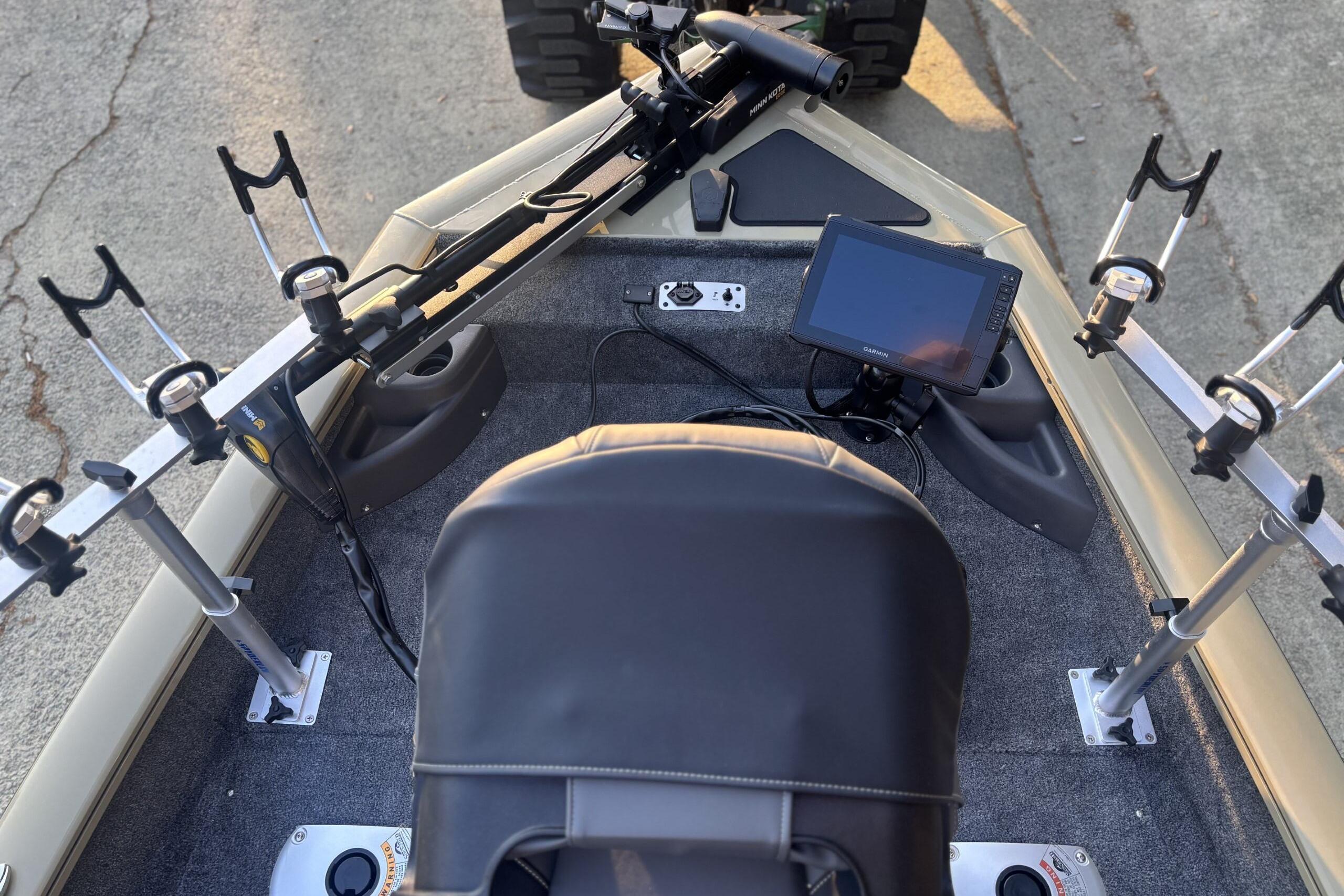 2026 Tracker Pro Team 175 Crappie Edition boat with fishing rod holders and navigation screen.