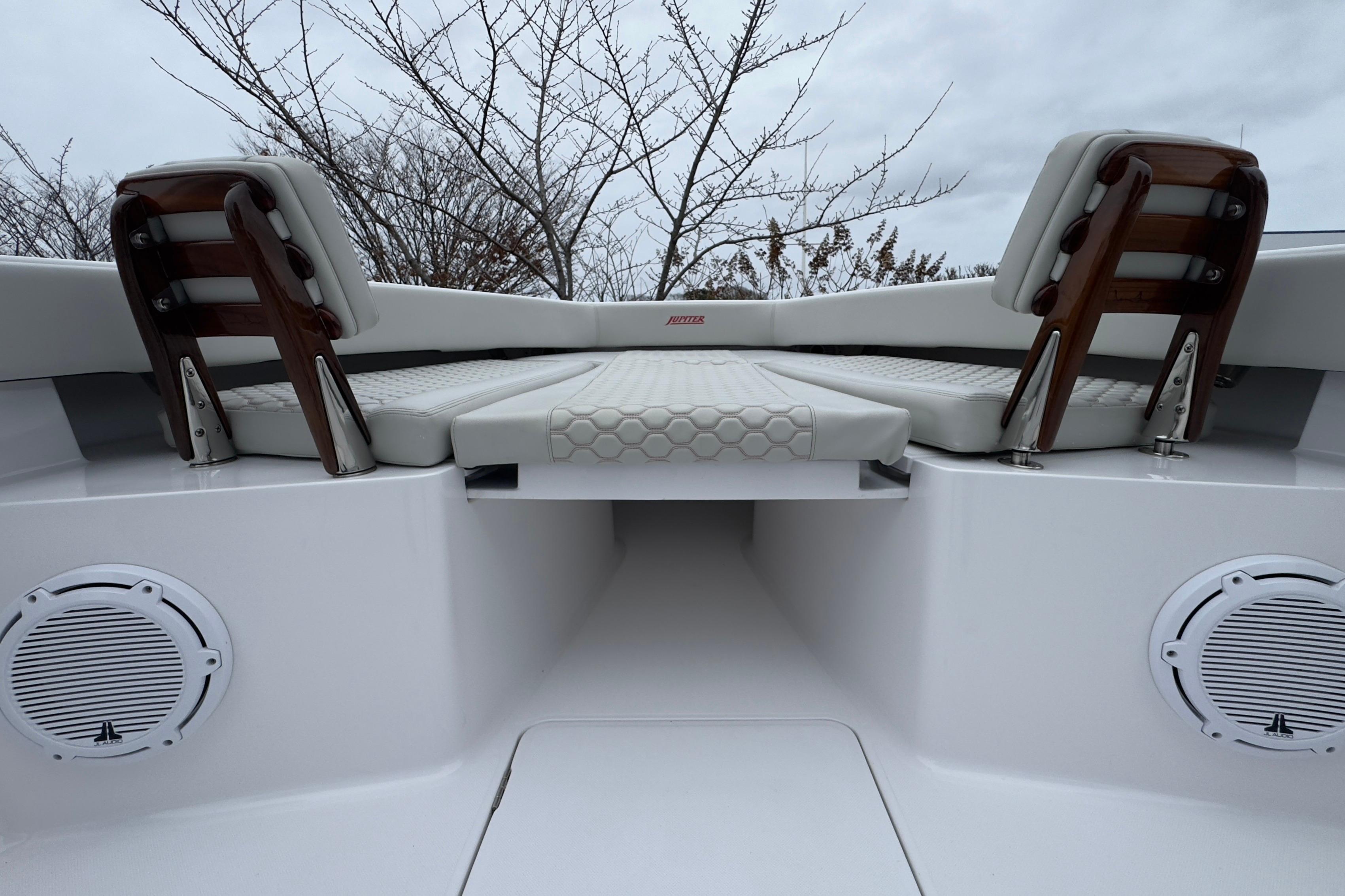 2024 Jupiter 32 FS boat interior with cushioned seating and speakers.