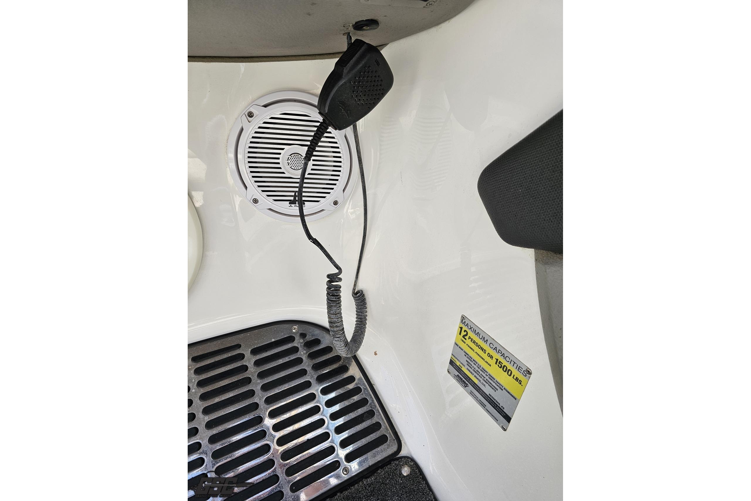 Interior of 2010 Cobalt 232 WSS boat with speaker, microphone, and capacity label.