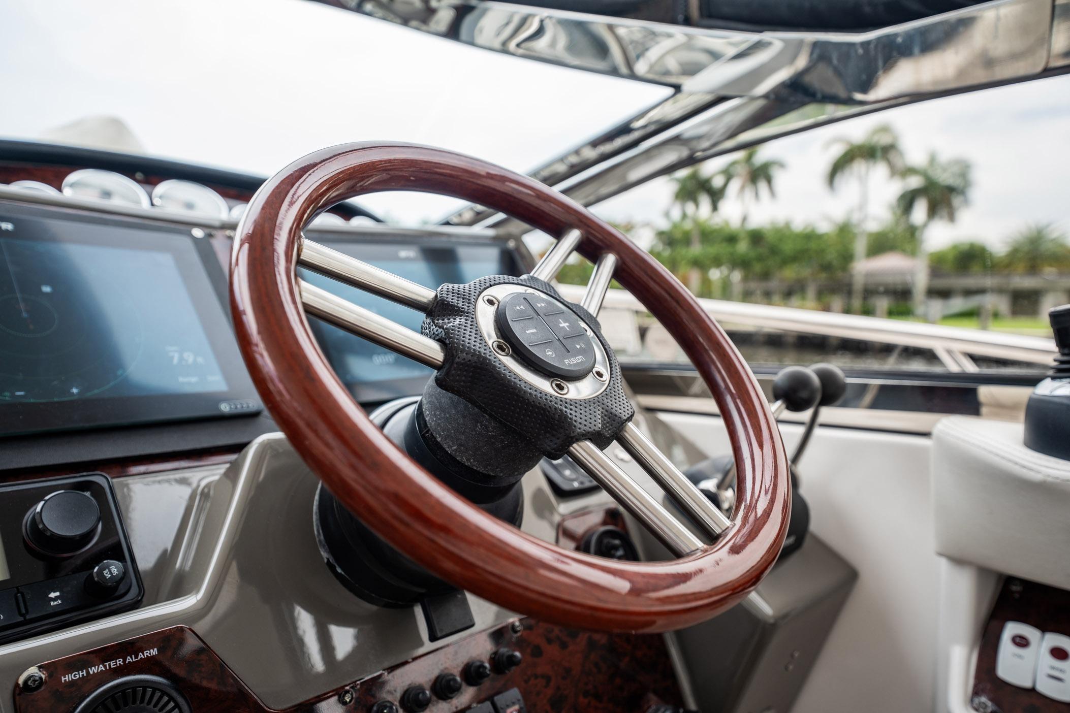 Steering wheel of 2008 Regal Commodore 4460 yacht with modern dashboard controls.