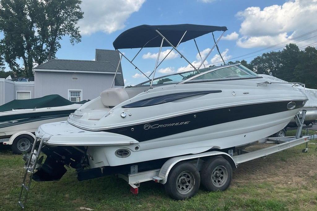 2015 Crownline 236 SC boat on trailer, parked outdoors under blue sky.