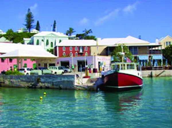 Colorful waterfront buildings and a Great Harbour N40 boat docked, 2025.