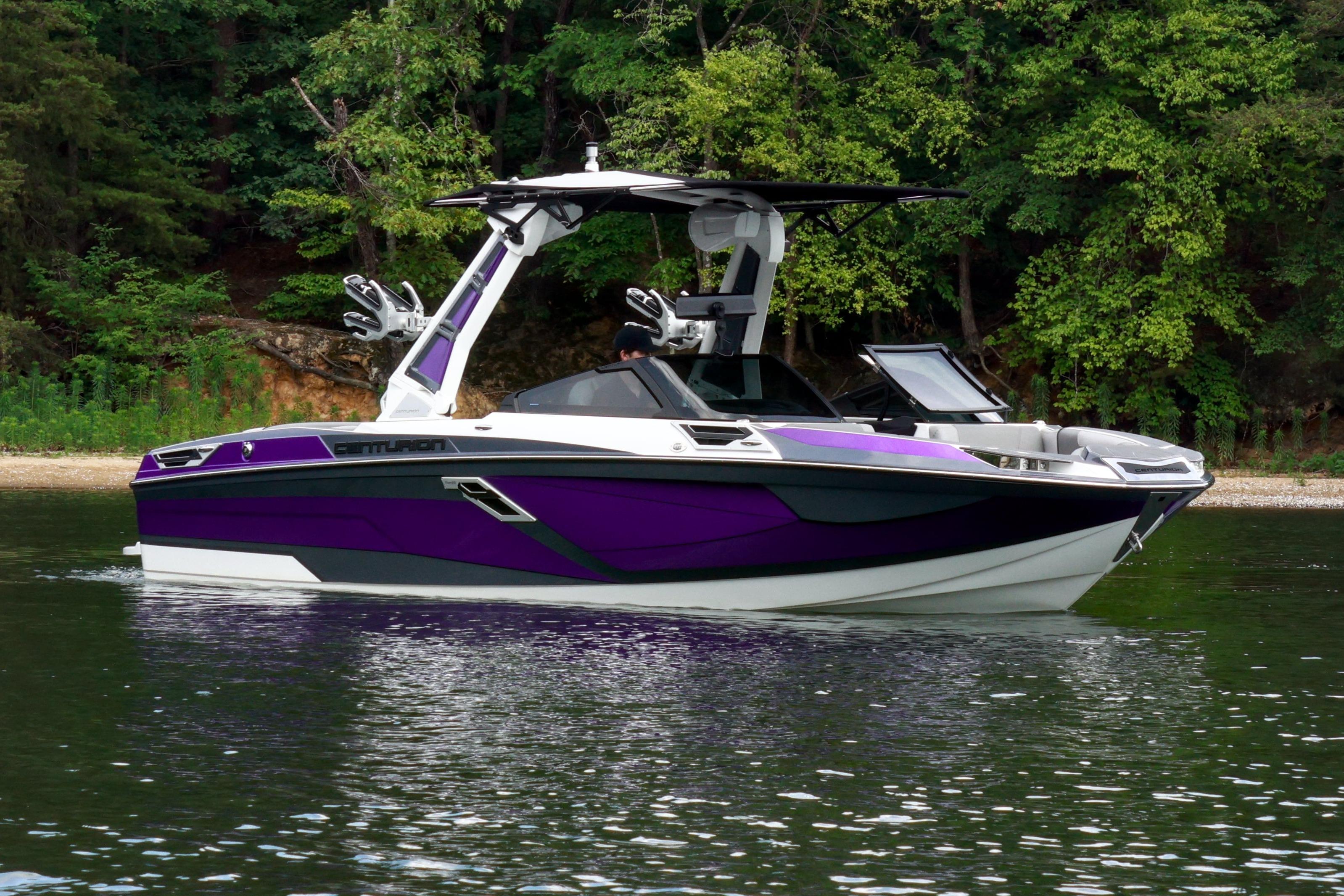 2022 Centurion Ri245 boat with purple accents on a calm lake.