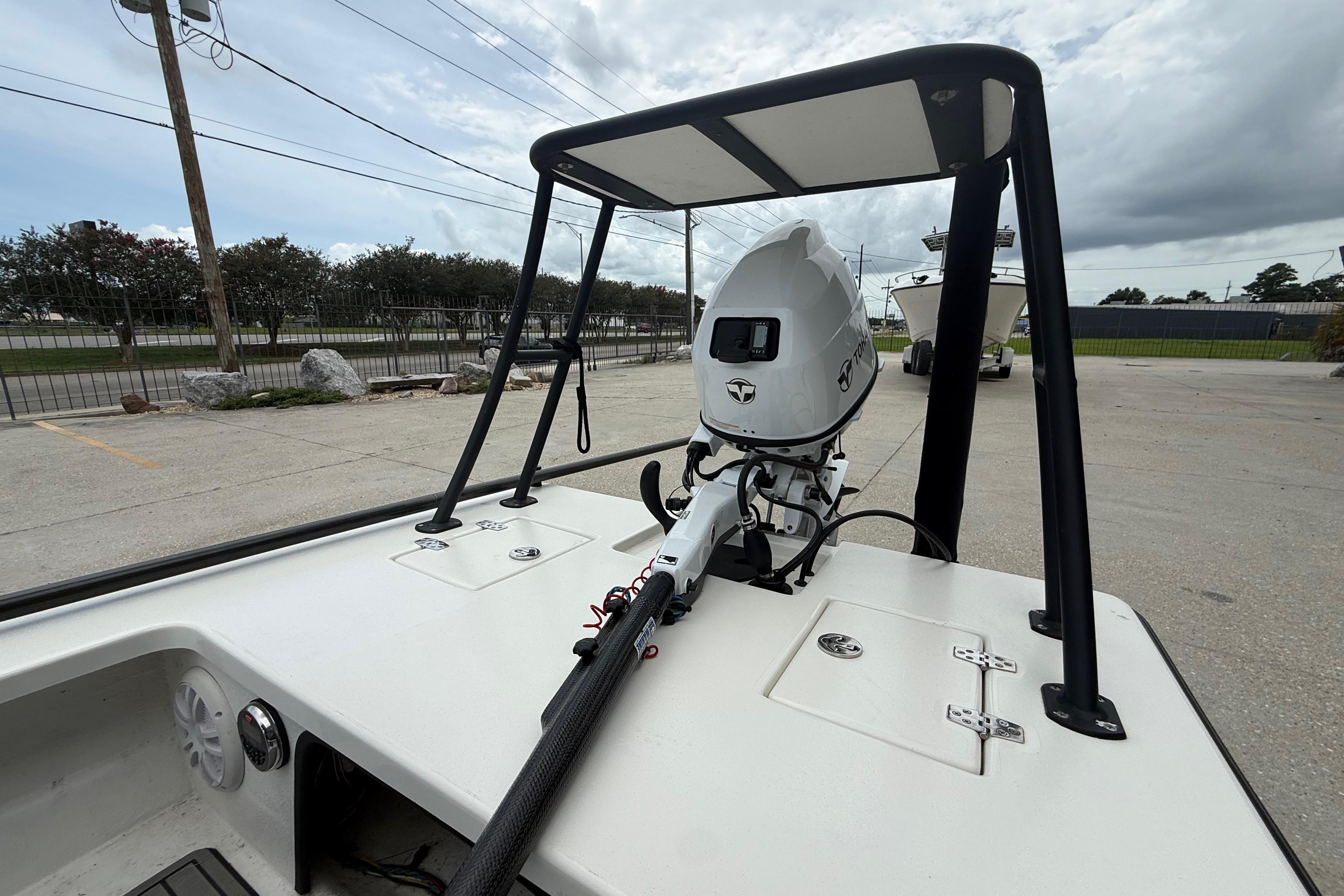 2020 Skimmer Skiff 14 boat with motor, parked outdoors on a cloudy day.