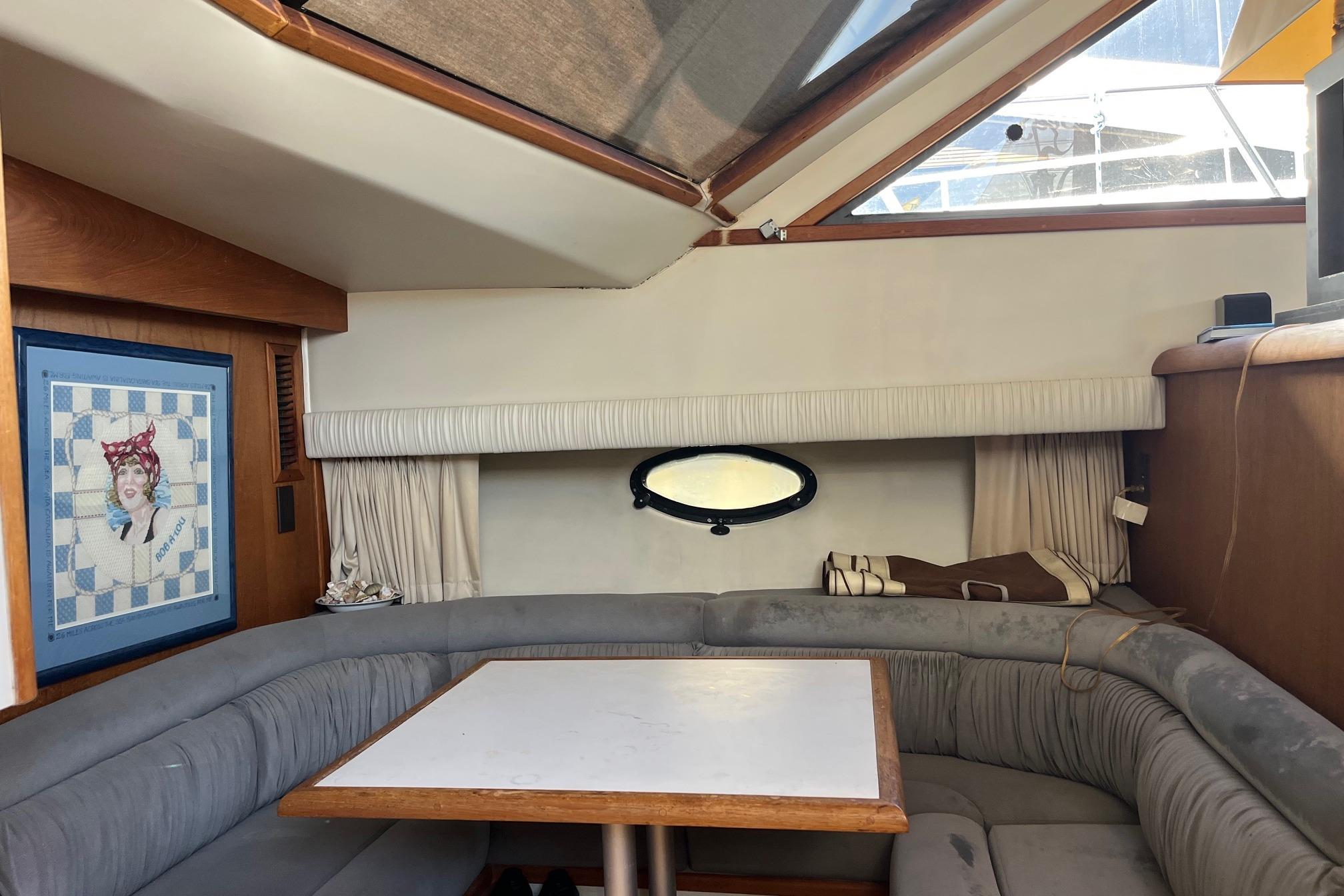 Interior of 1990 Californian 52 Cockpit Motor Yacht with cozy seating and nautical decor.