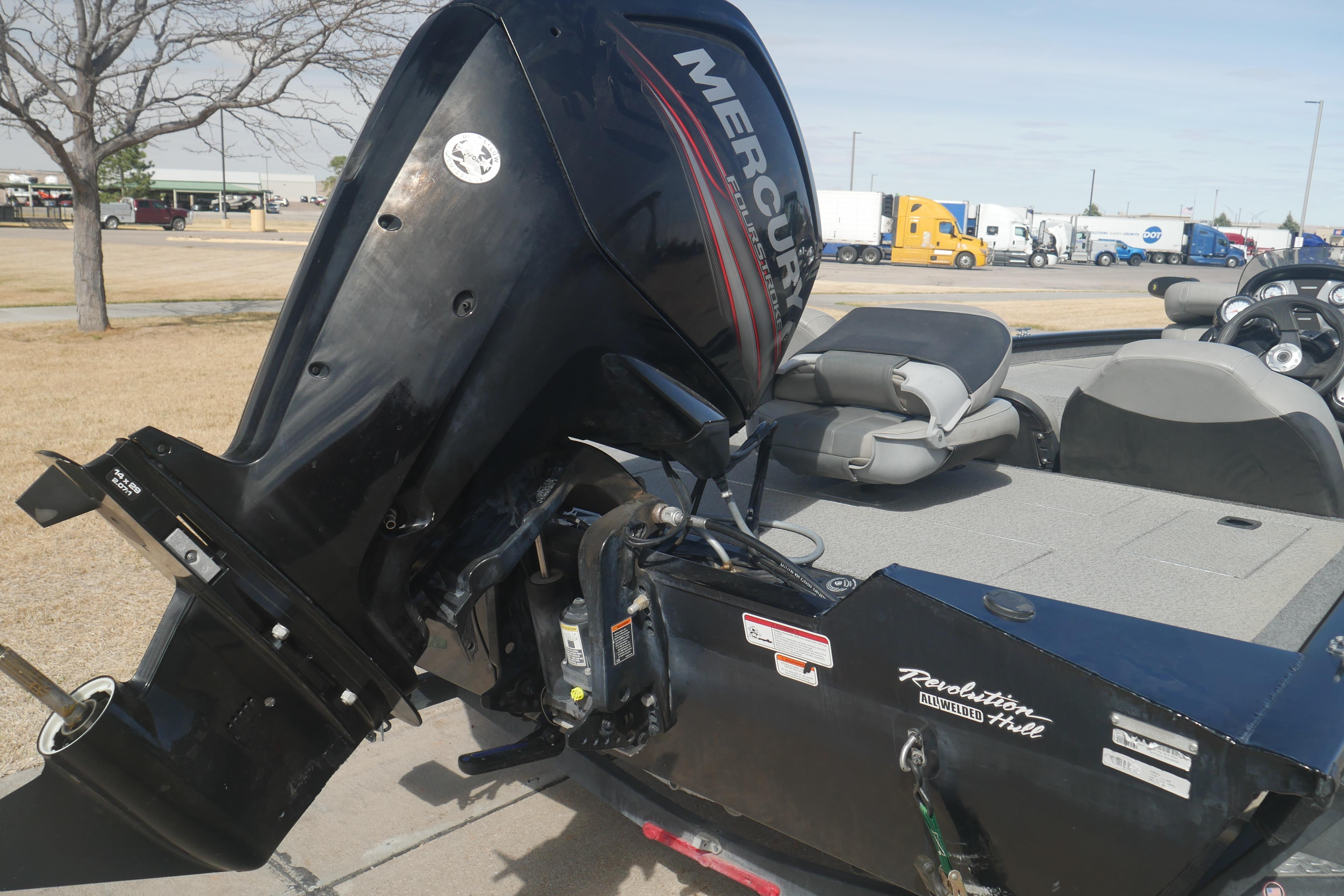 2018 Tracker Pro Team 175 TXW boat with Mercury outboard motor in parking lot.