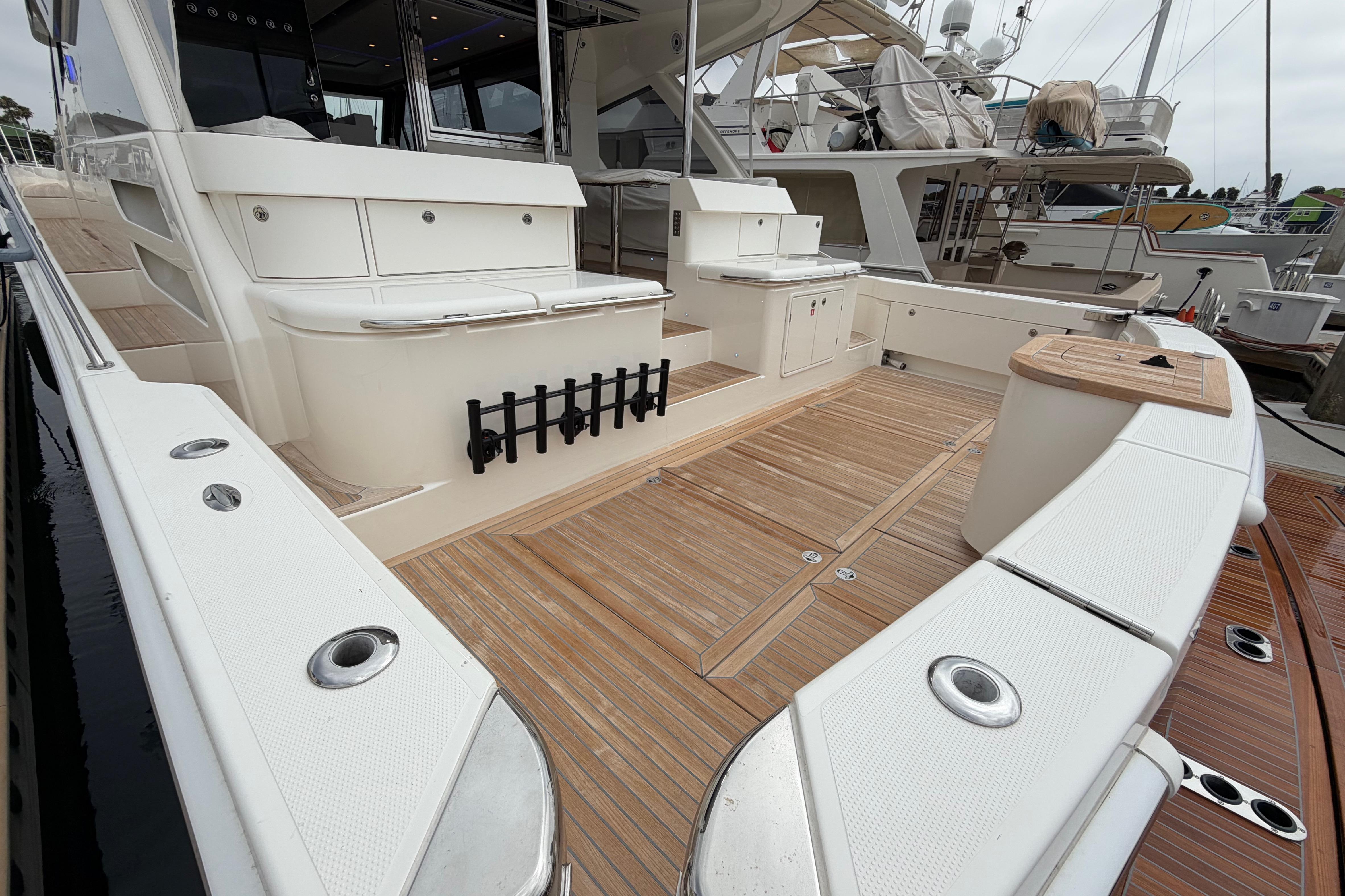 Luxury 2023 Riviera 645 SUV yacht deck with elegant wood finish and spacious seating area.