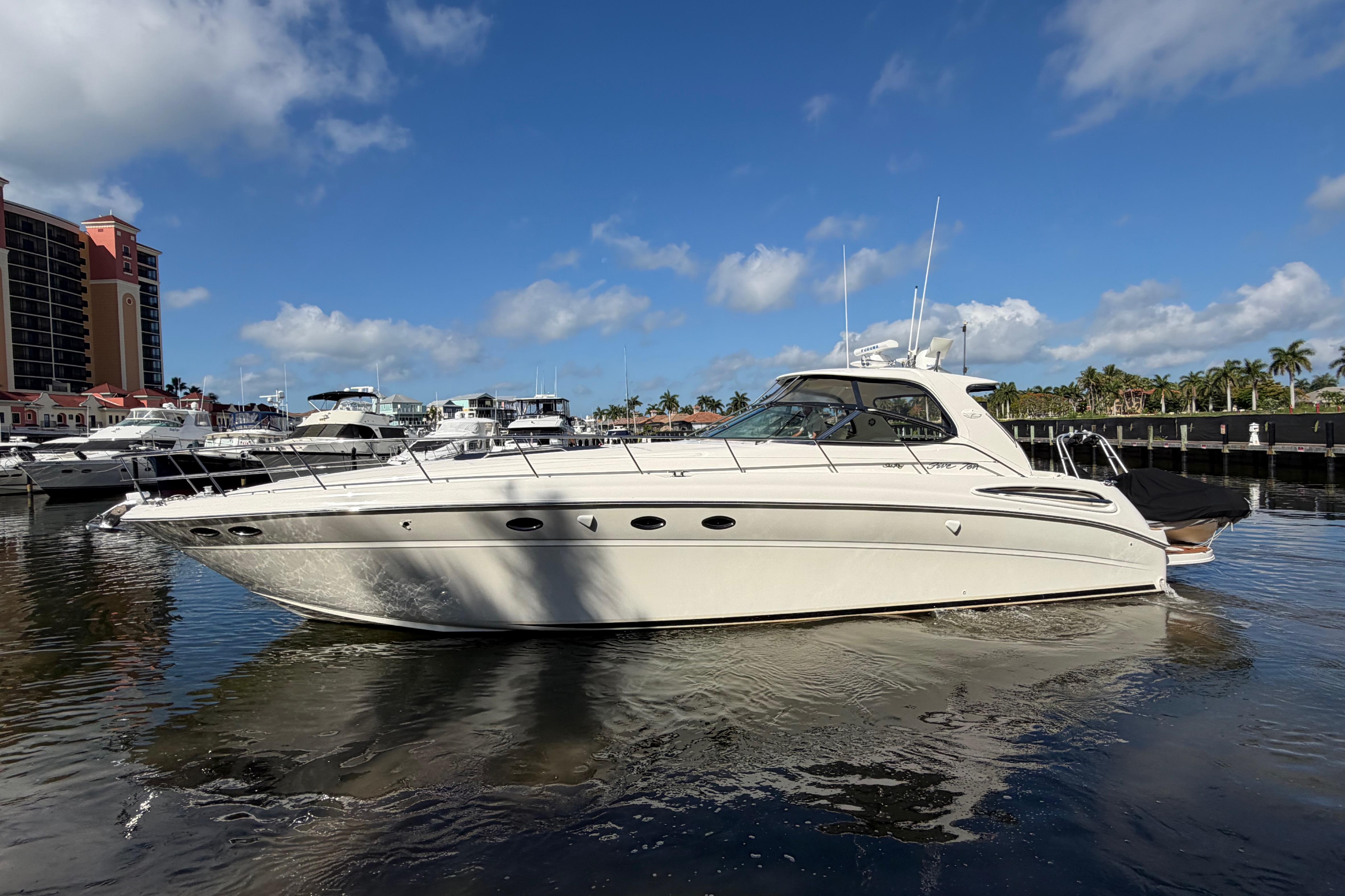 2001 Sea Ray Sundancer 510 yacht docked in marina under clear blue sky.