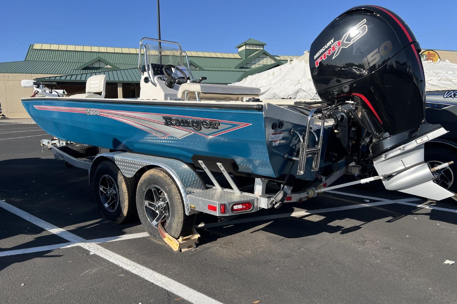 2024 Ranger RB200 boat with Mercury engine, parked on a trailer in a lot.