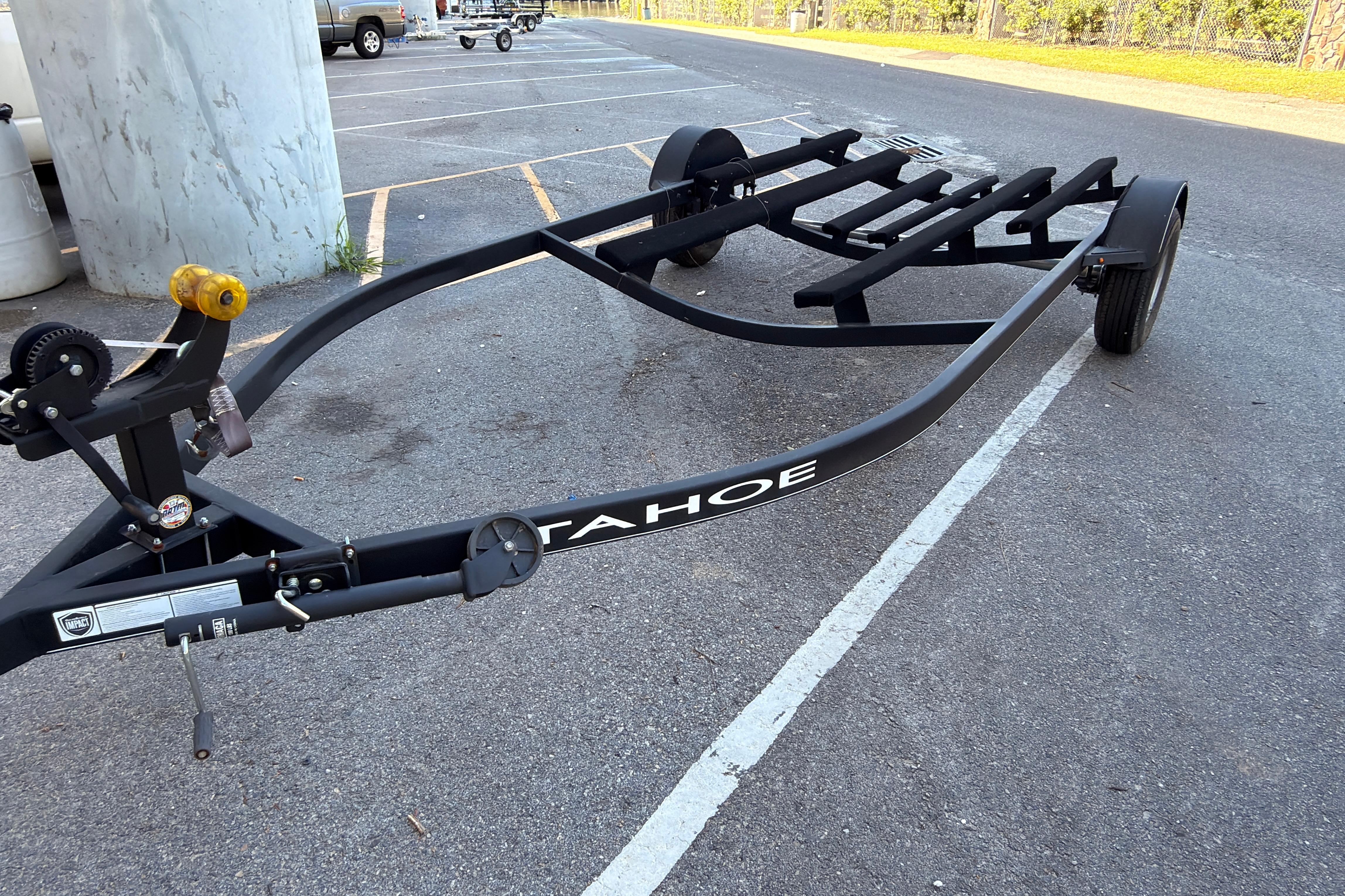 2022 Tahoe T18 boat trailer parked in a lot, featuring sturdy black frame.