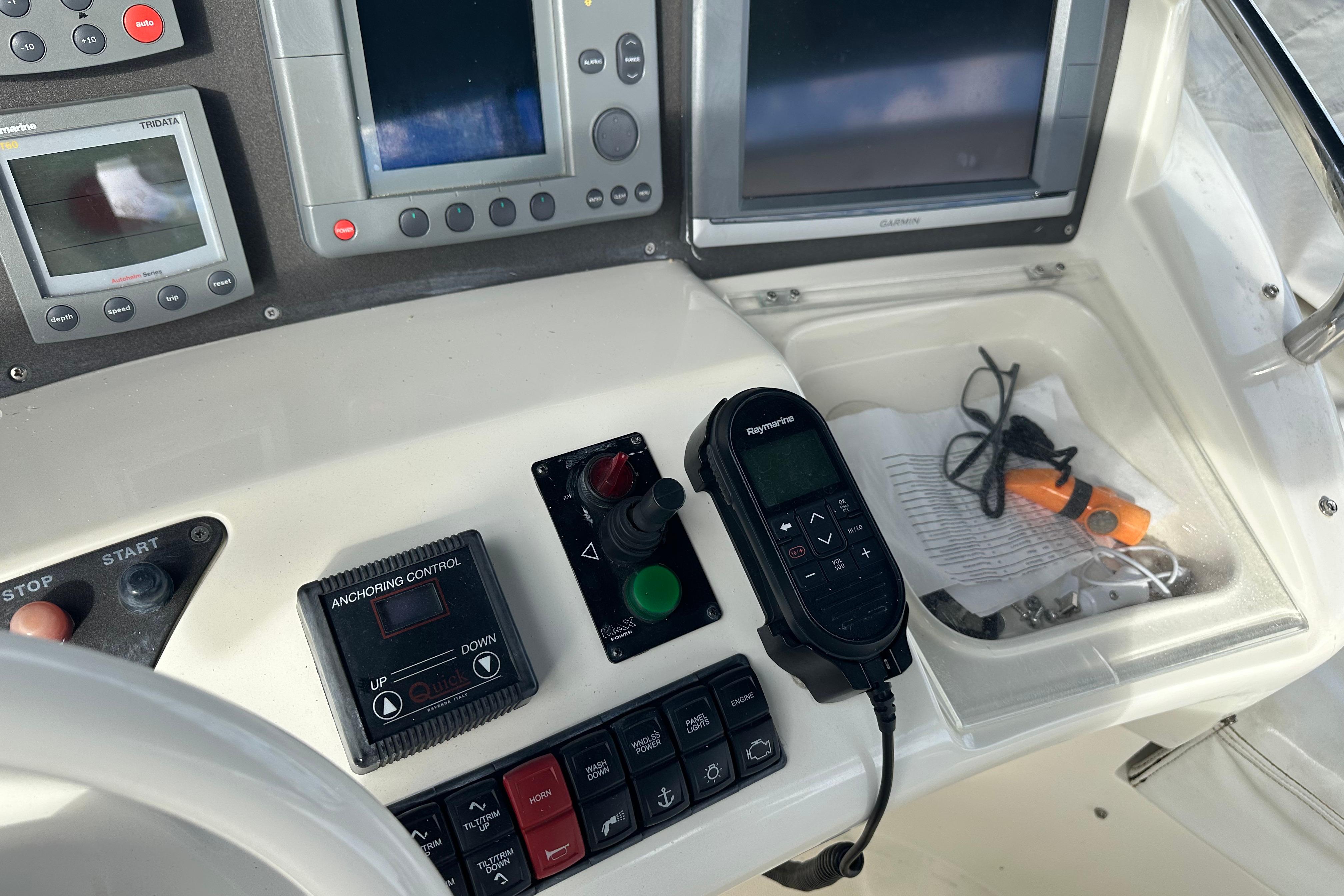 Control panel of a 2004 Azimut 55E yacht with navigation equipment and controls.