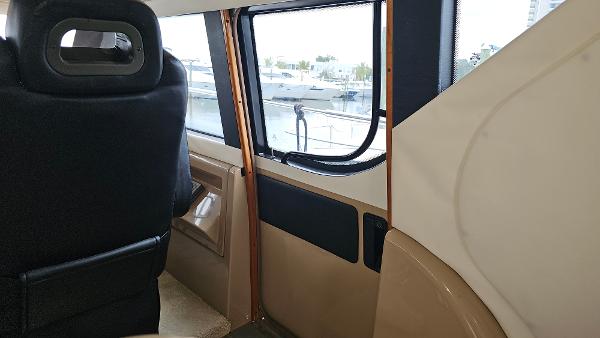 Interior view of 2000 Carver 450 Voyager Pilothouse, showcasing seating and window details.