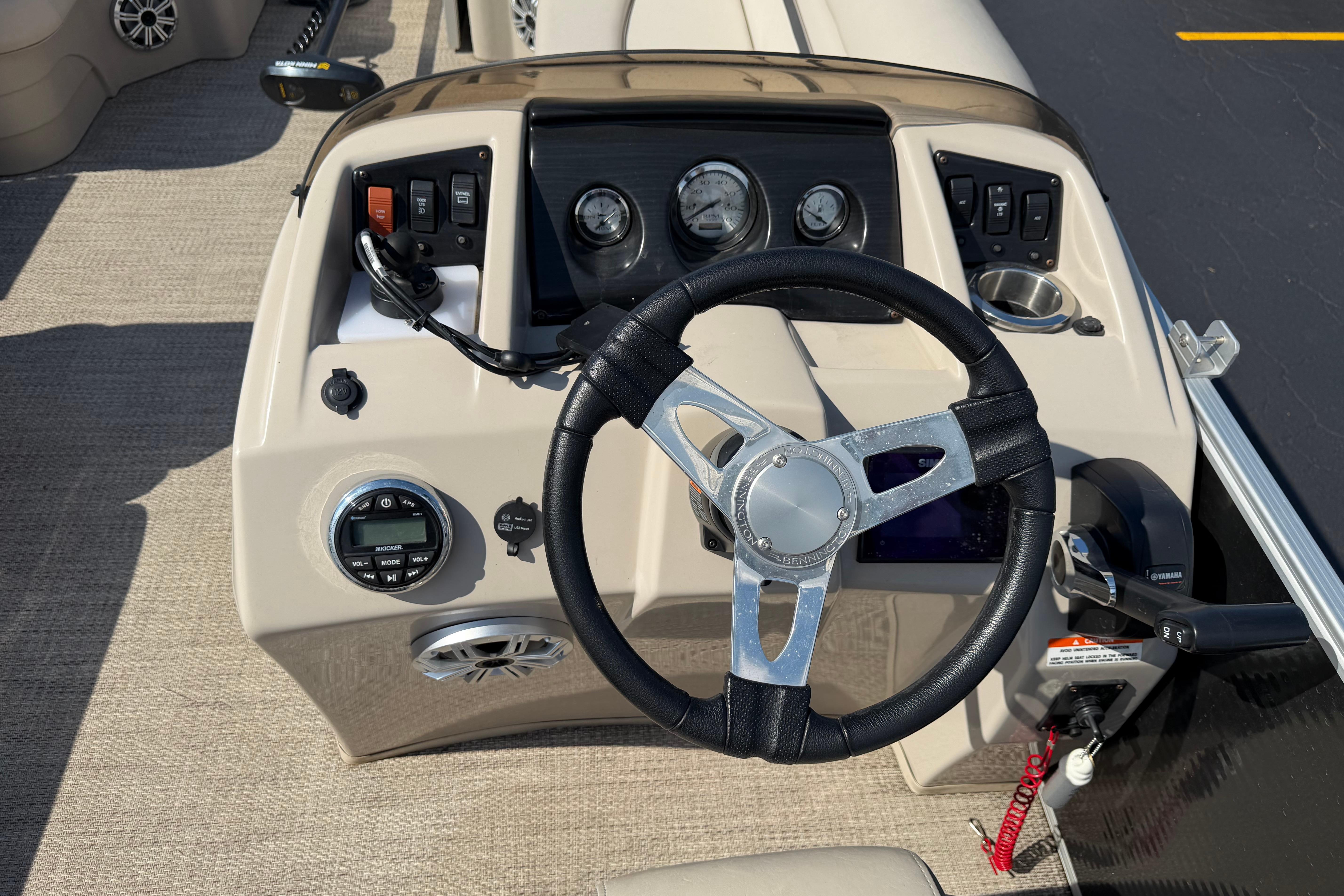 Steering console of a 2018 Bennington 21 SF boat with gauges and controls.