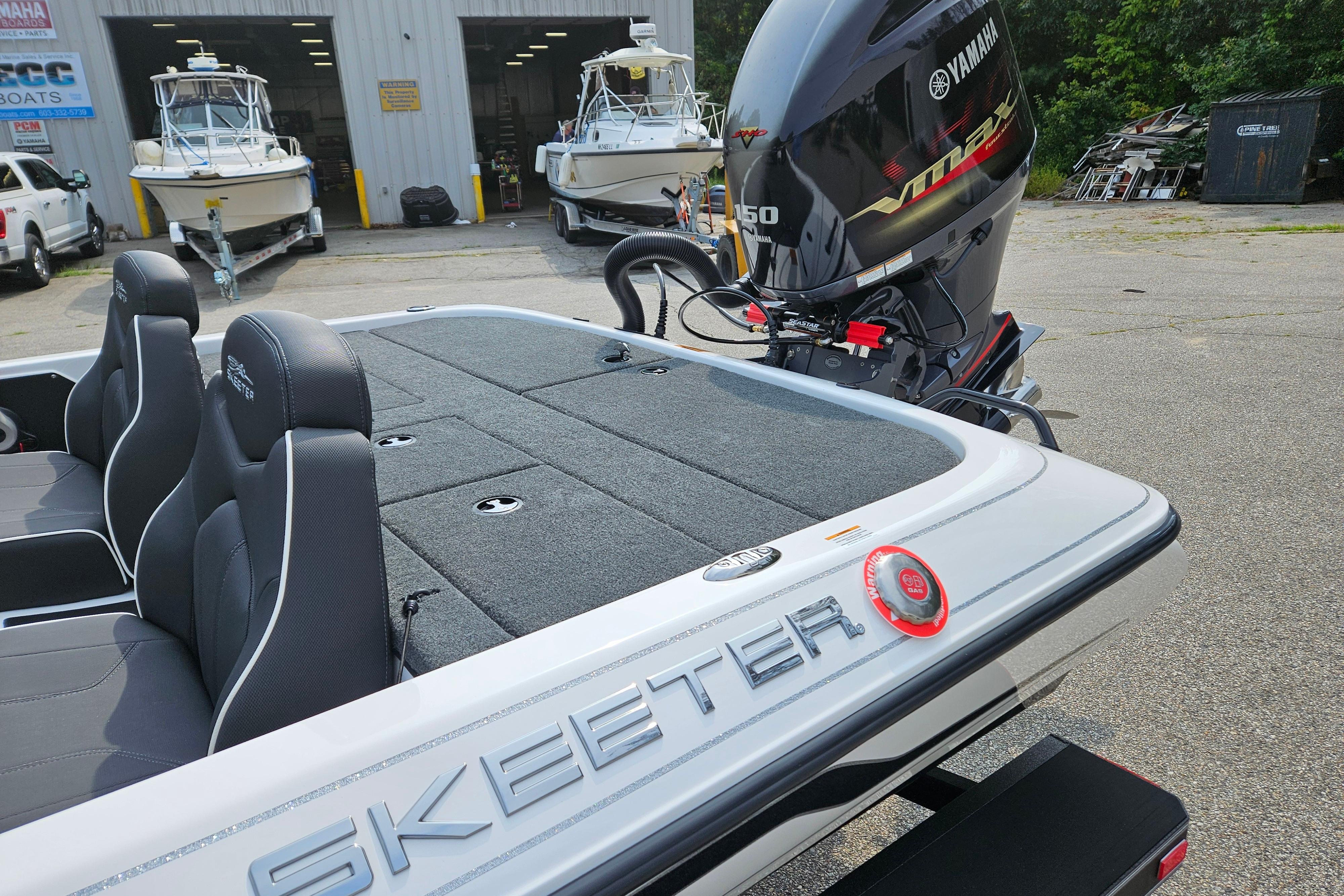 2026 Skeeter ZX150 boat with Yamaha engine, parked near a marine service center.