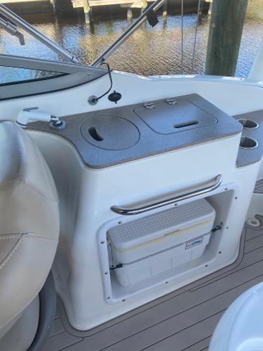 2015 Hurricane SunDeck 2400 OB boat interior with storage and seating.