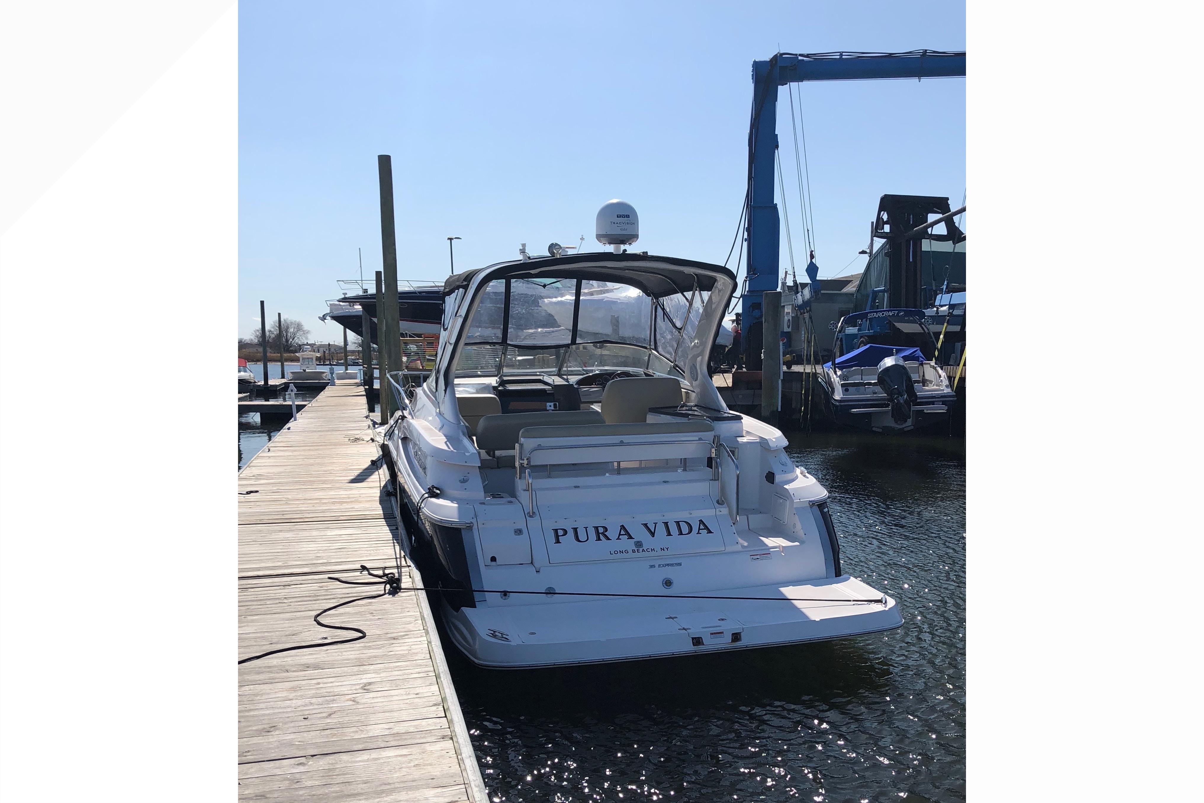 2012 Regal 35 Express Cruiser docked at marina, rear view.