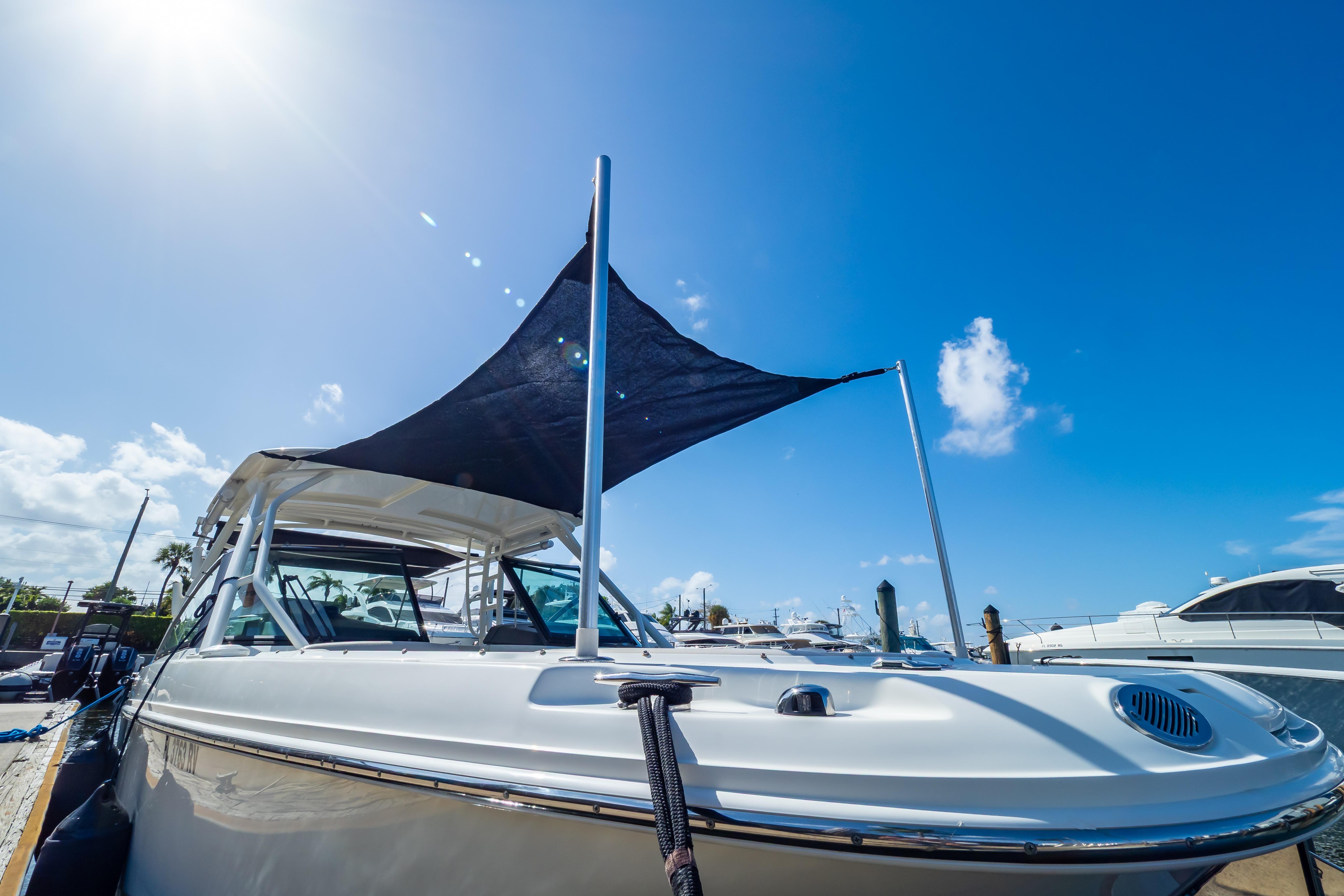 2019 Boston Whaler 270 Vantage boat docked under clear blue sky.