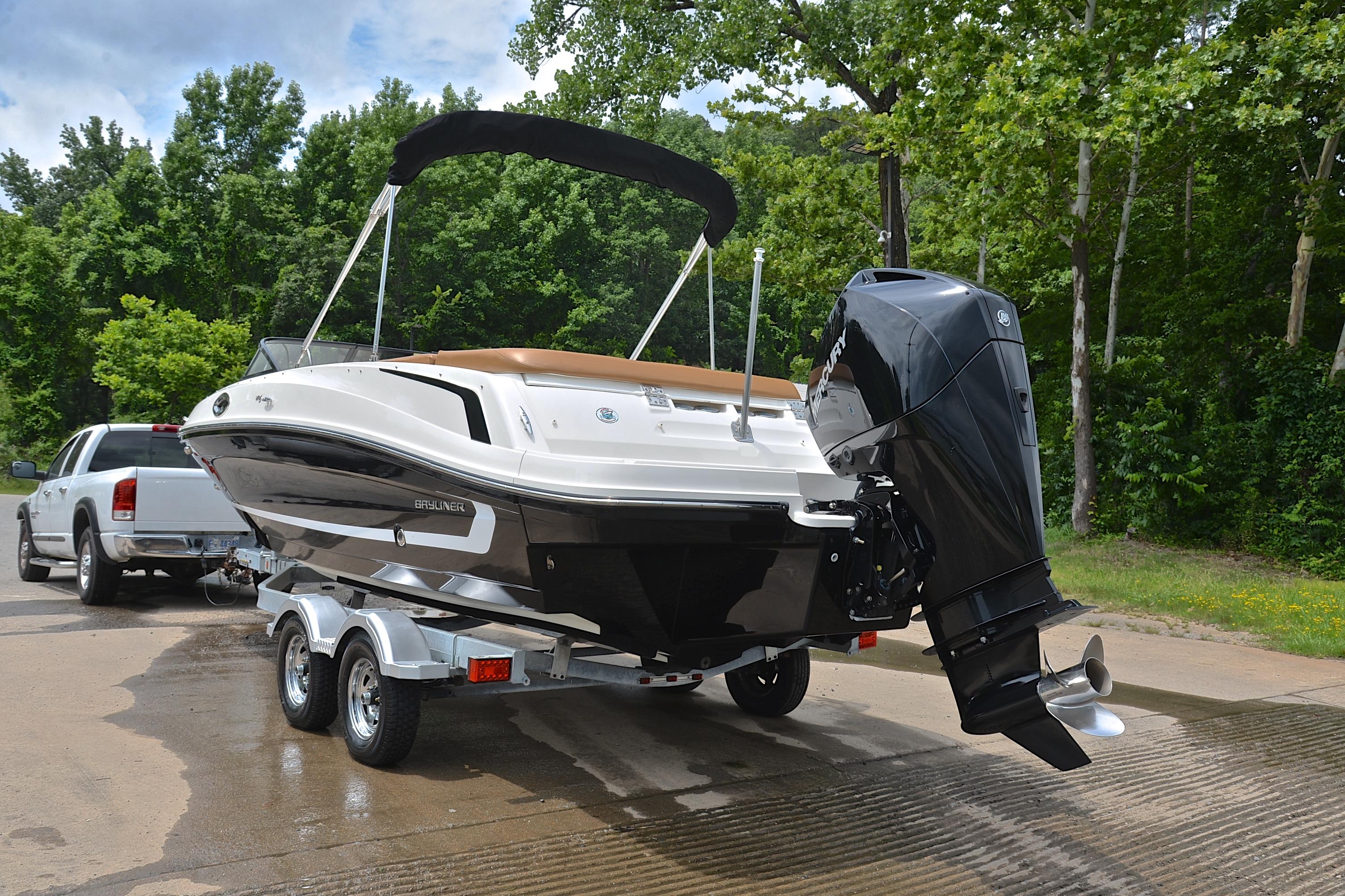 2019 Bayliner VR6 Bowrider OB on trailer, parked near lush green trees.
