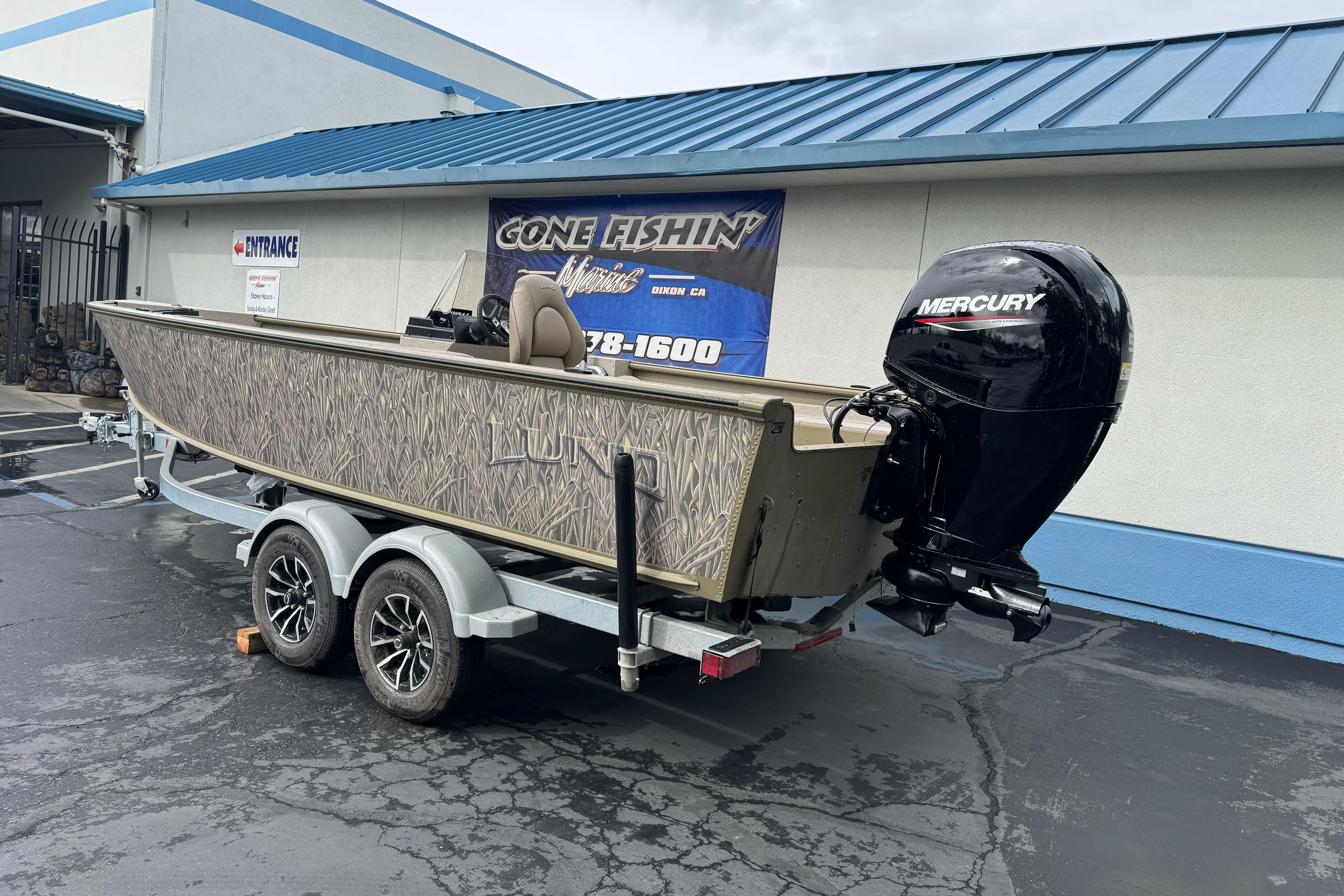 2026 Lund 2075 Alaskan SS boat on trailer with Mercury outboard motor.