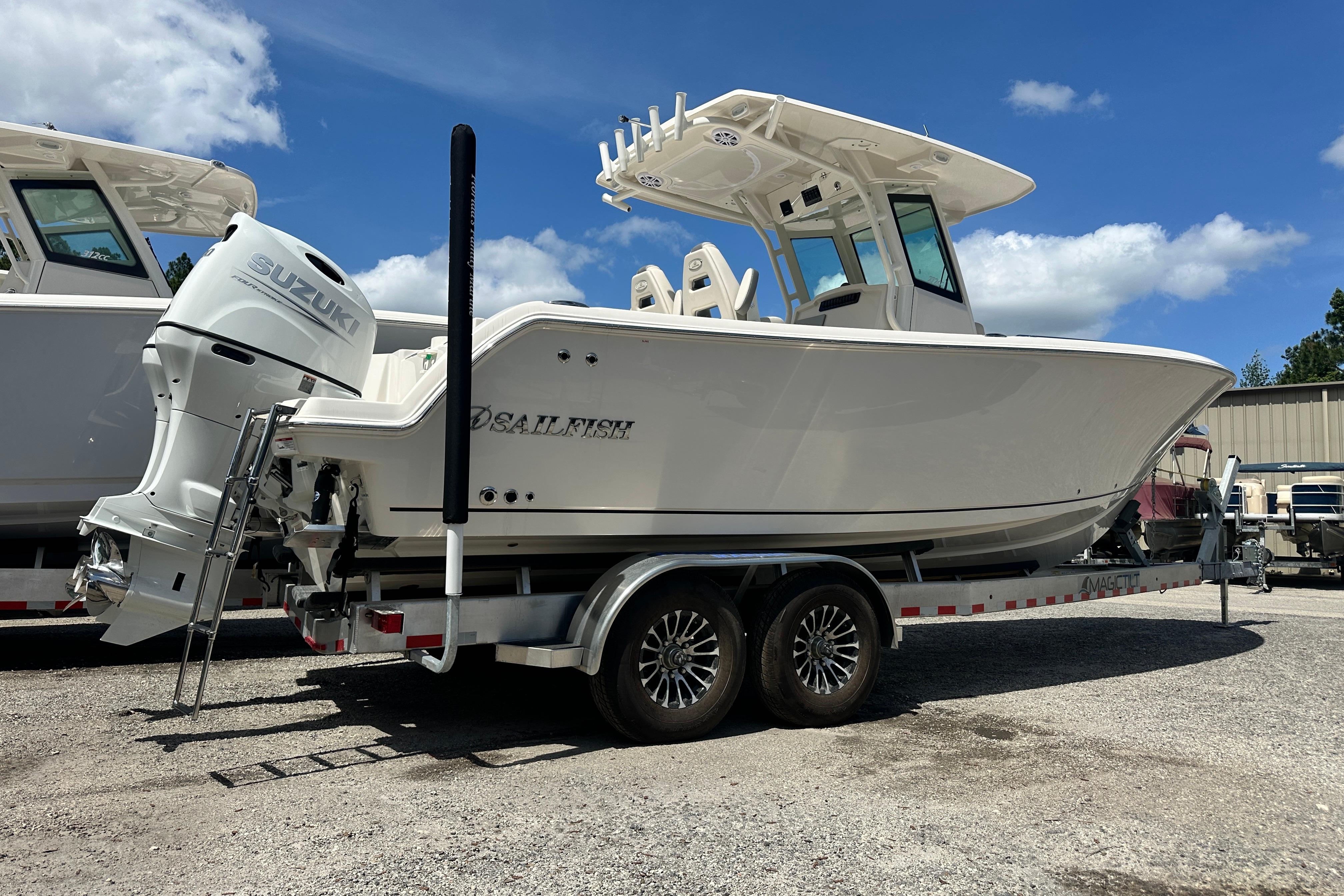 2026 Sailfish 272 CC boat on trailer with Suzuki outboard motor, under clear blue sky.