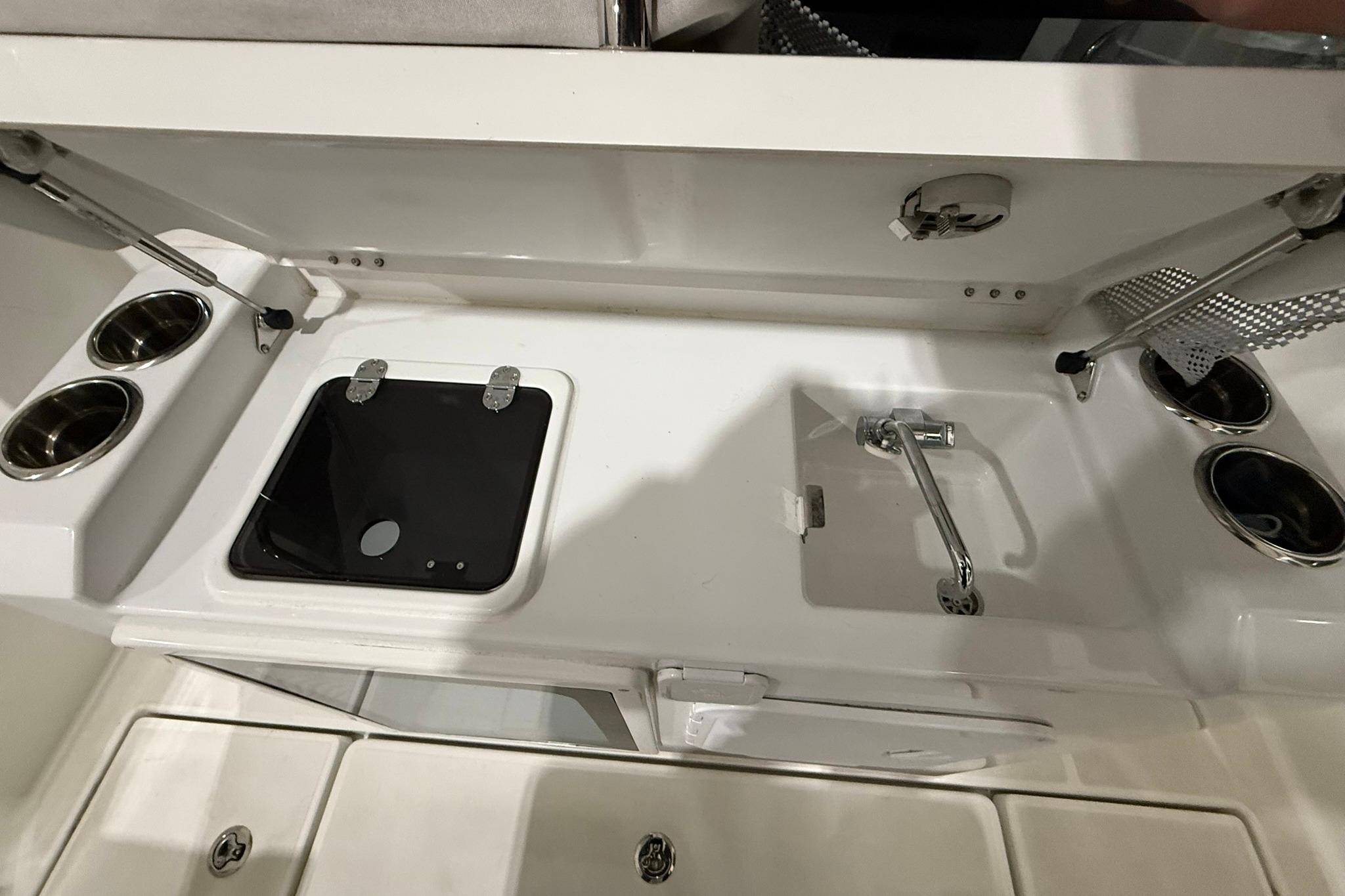 2024 Jeanneau NC Sport 795 Series 2 boat kitchen with sink and stove.