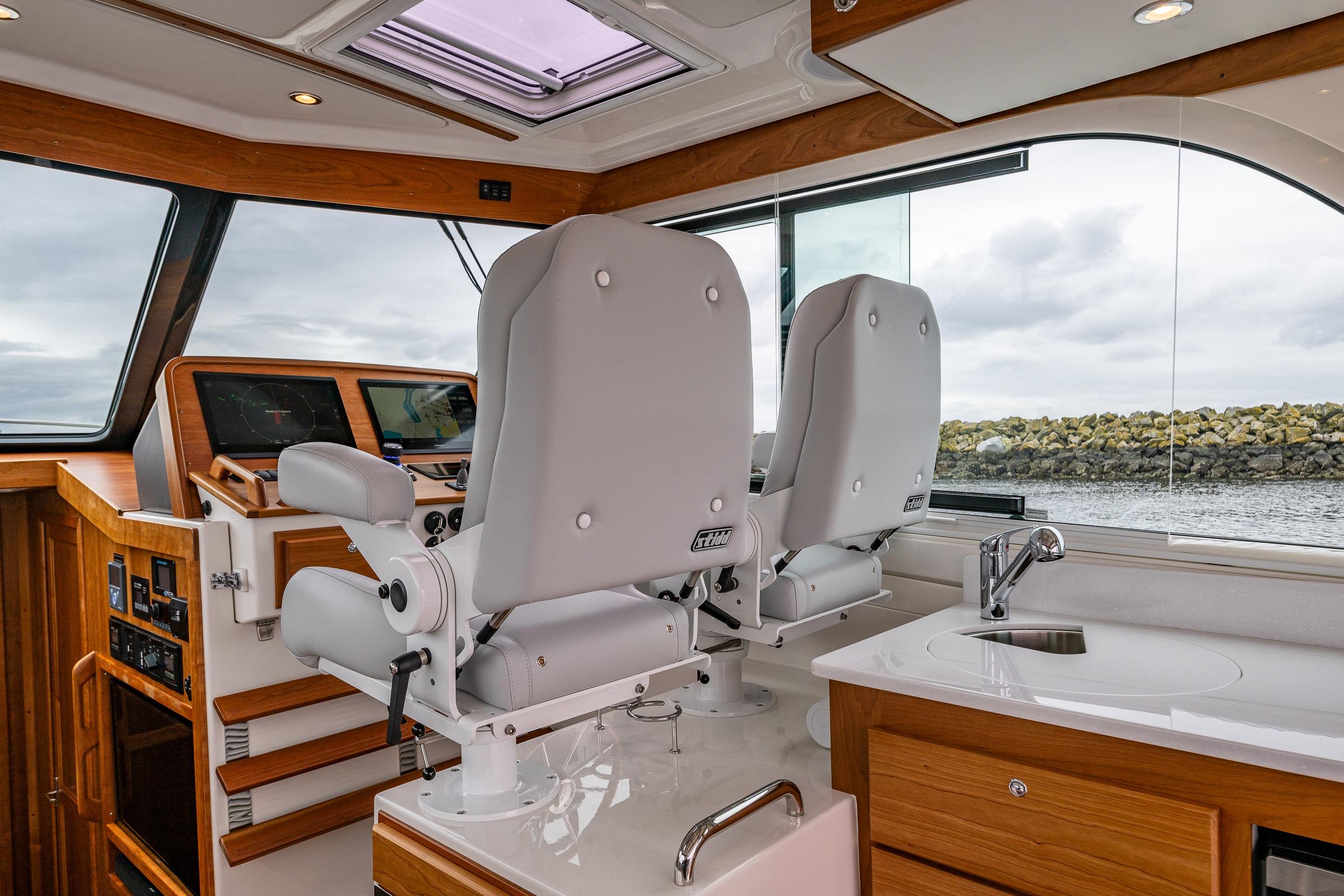 Interior of 2025 Back Cove 39O yacht with helm seats and navigation equipment.