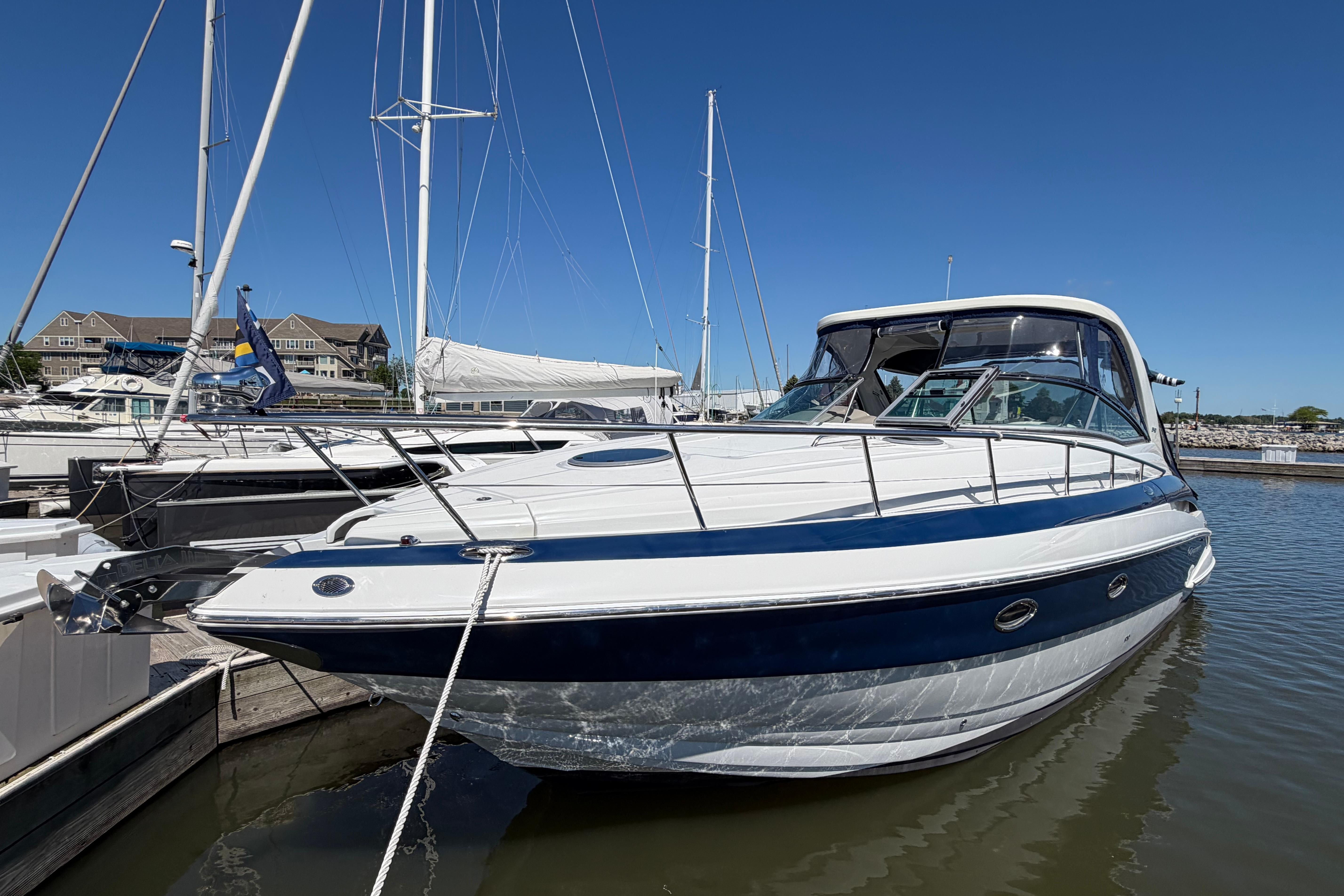 2008 Crownline 340 CR boat docked in marina under clear blue sky.