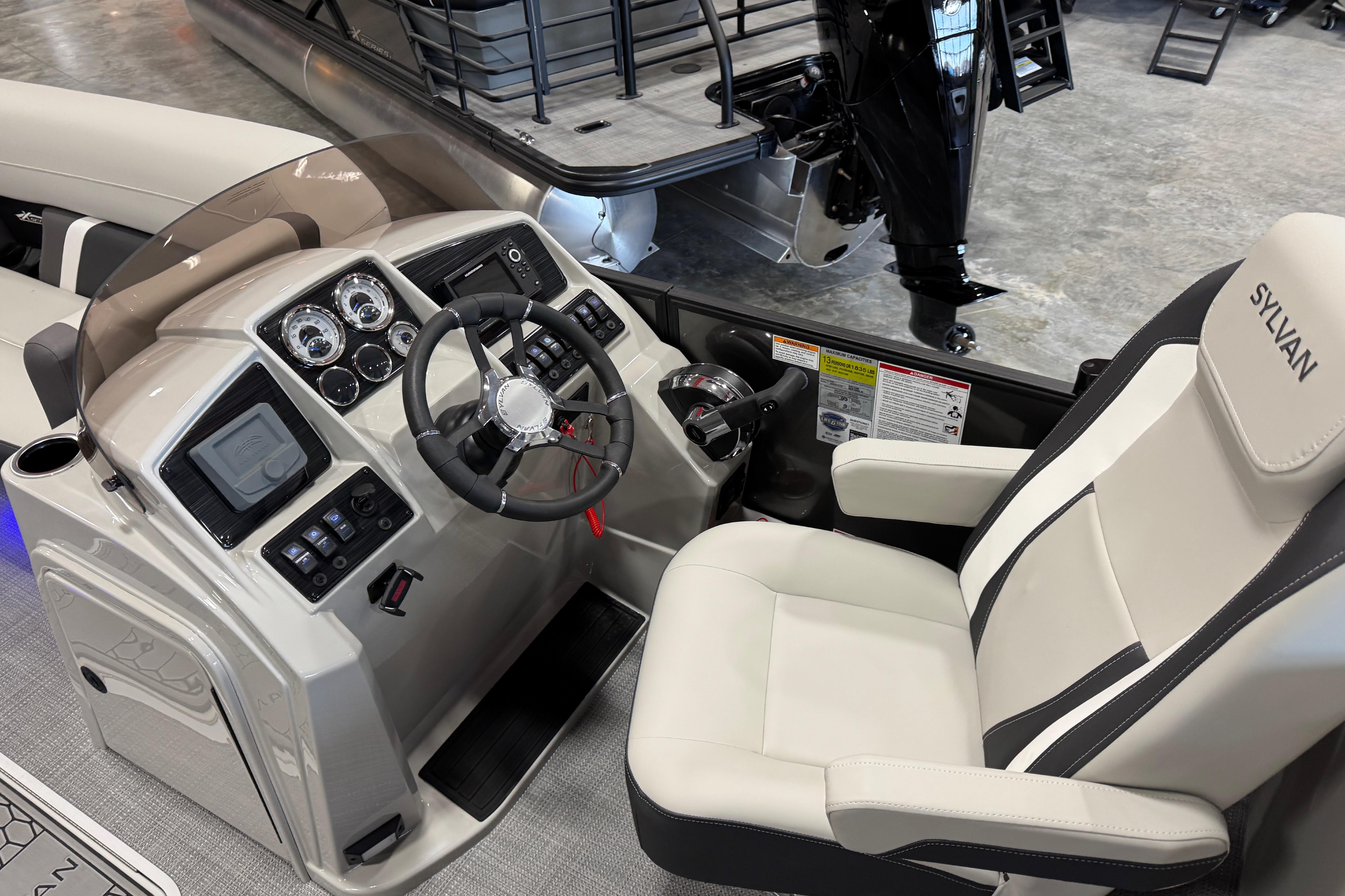 Interior view of 2026 Sylvan Mirage X X5 boat cockpit with modern controls and steering.