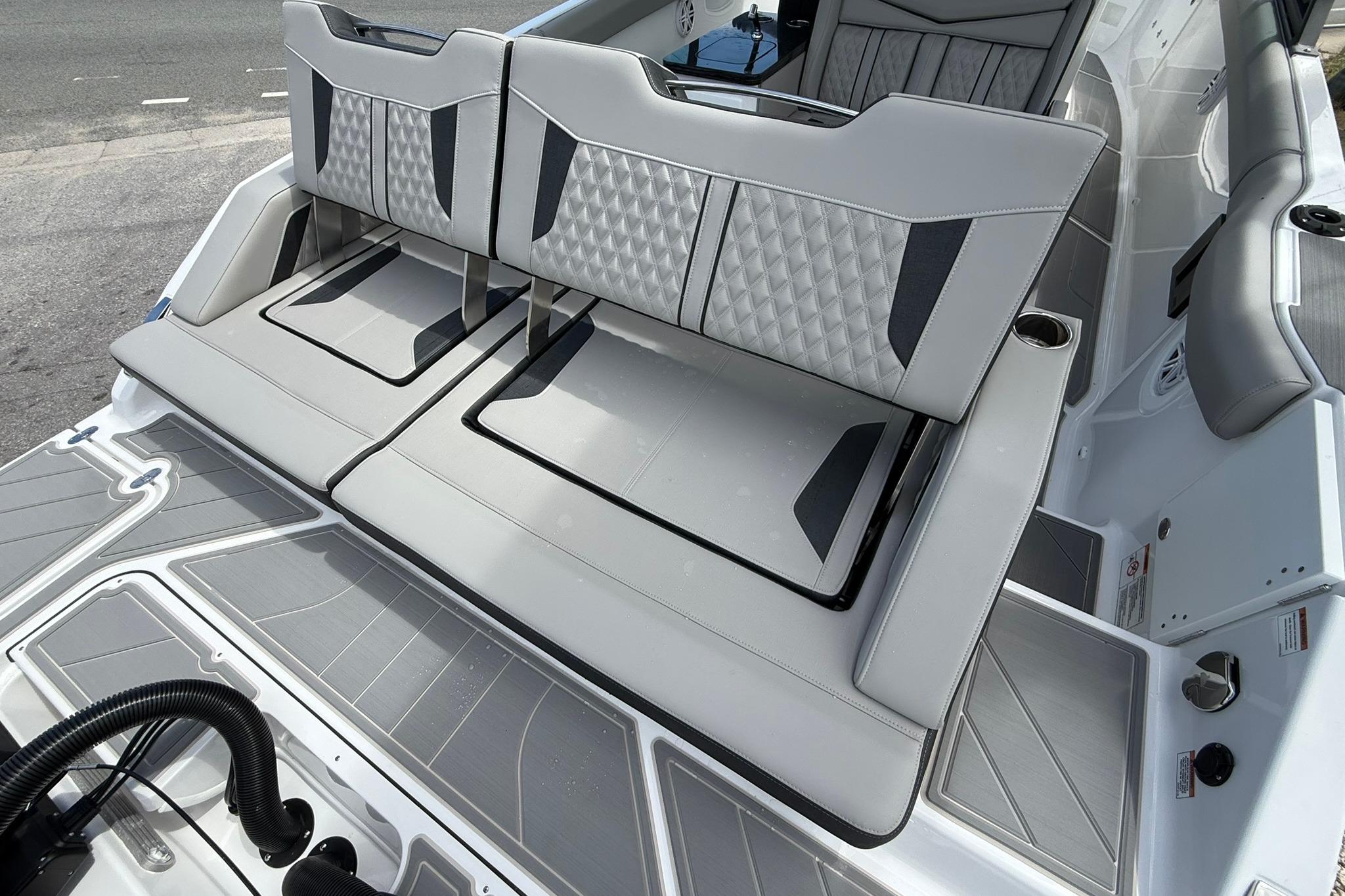 Luxury seating on 2027 Monterey Elite 30 OB boat, featuring sleek gray upholstery and modern design.