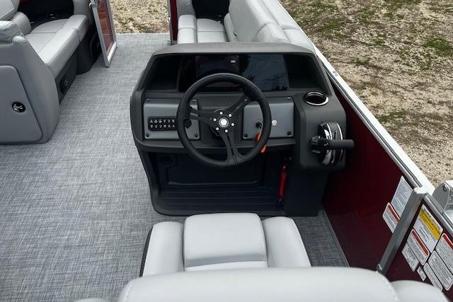 2026 Sun Tracker Party Barge 20 DLX interior with steering console and seating.