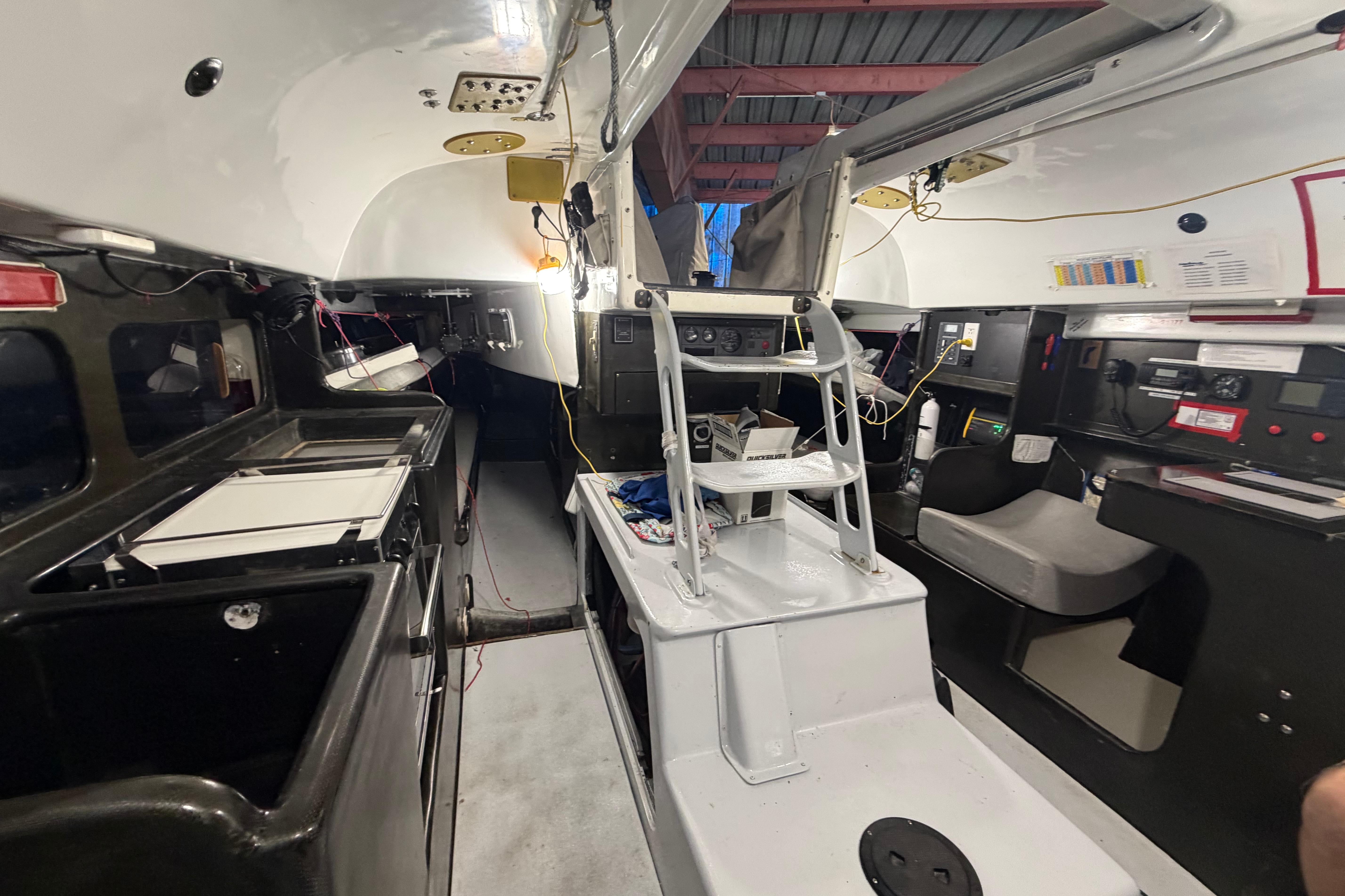 Interior of Andrews 63 sailboat, featuring navigation equipment and compact living space.