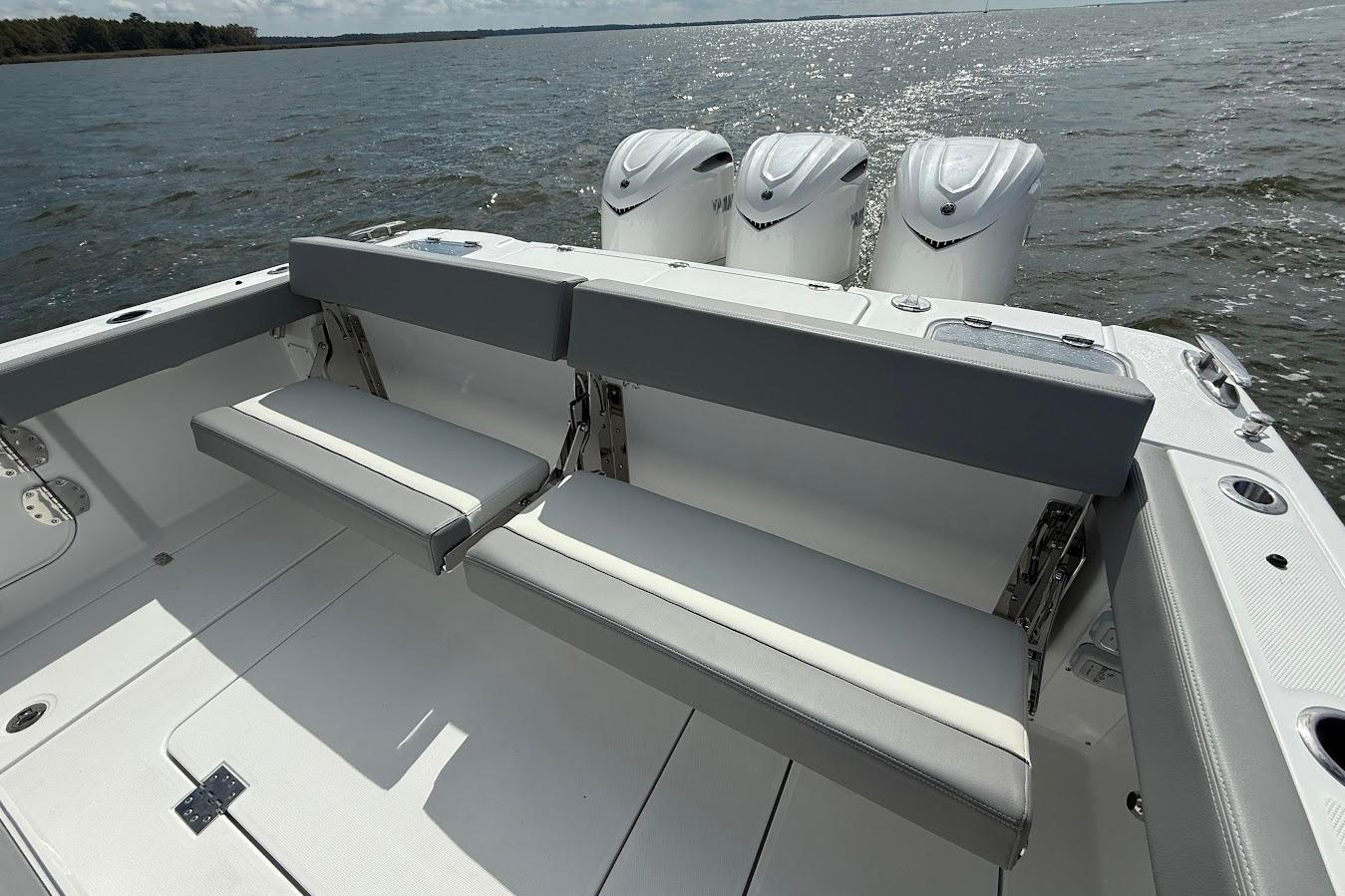 2026 Everglades 375 Center Console boat with triple engines and foldable seating on open water.
