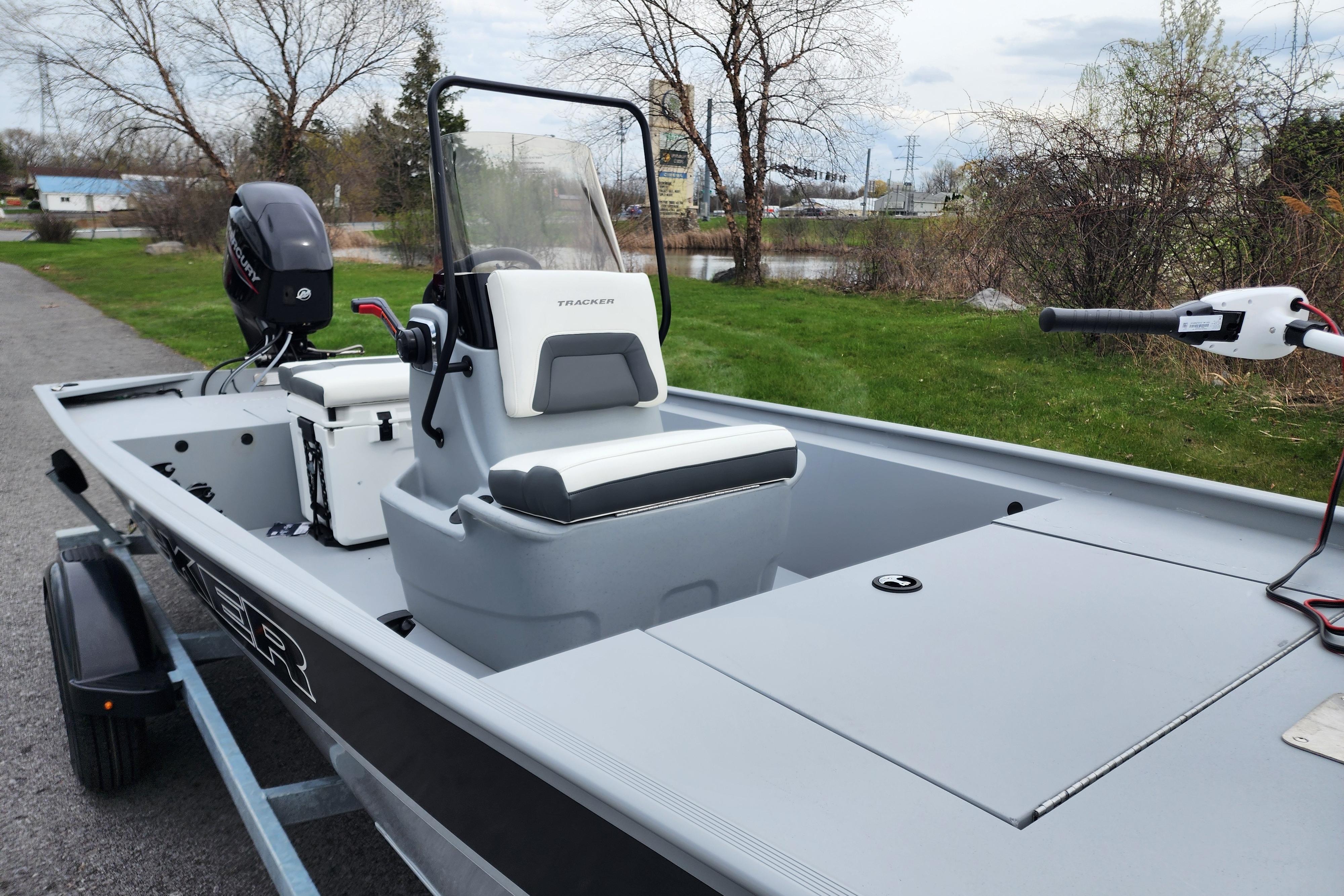 2026 Tracker Bass Tracker Classic CC boat on trailer, parked near a lake.