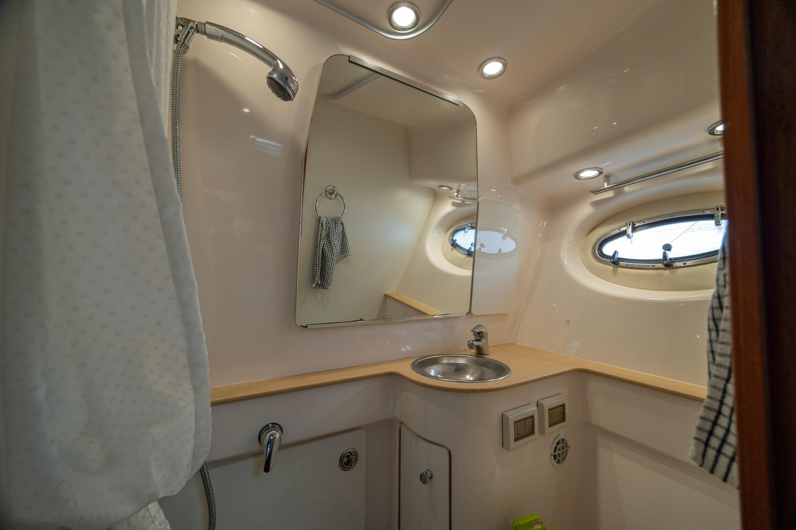 Luxurious bathroom in 2004 Tiara Yachts 3200 Open, featuring sink and mirror.