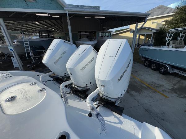 2025 Yellowfin 39 Offshore boat with triple Mercury outboard engines in a marina.