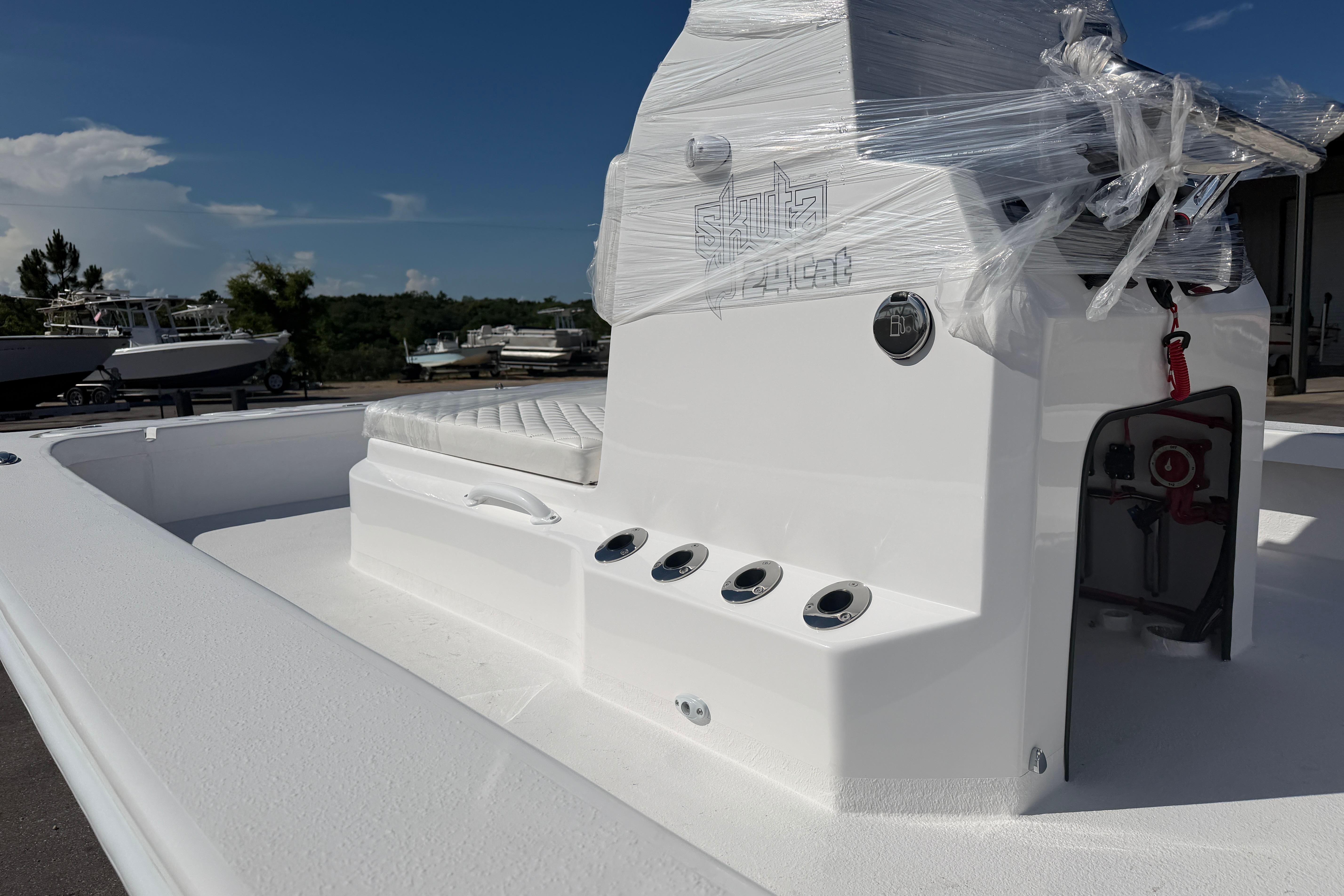 2026 Skuta 24 Cat boat with sleek white design and modern features.