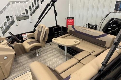 2026 Bennington 22SXSB pontoon boat interior with beige seating and a central table.