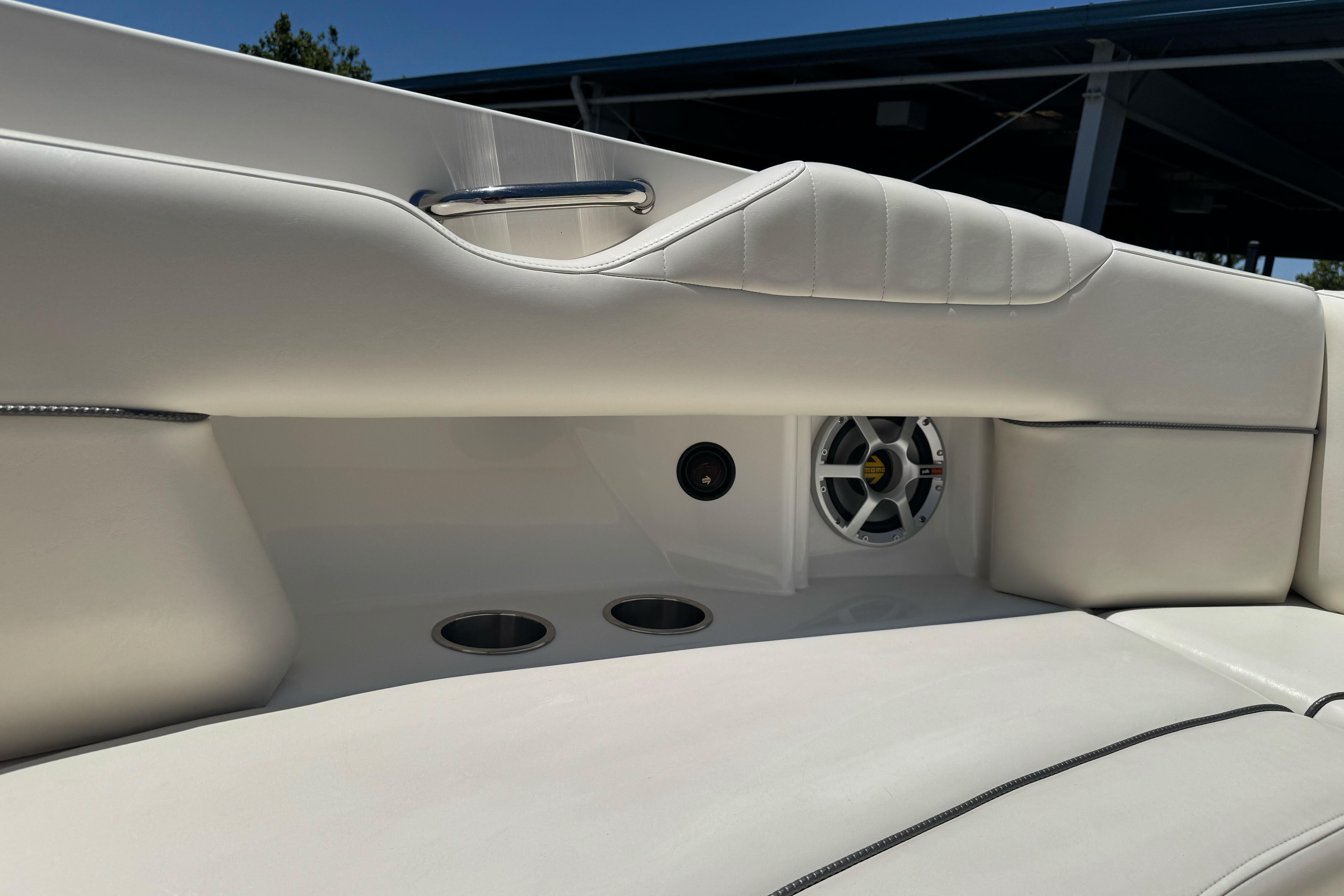 Interior of 2007 Sea Ray SLX 250 boat with white seating and speaker system.