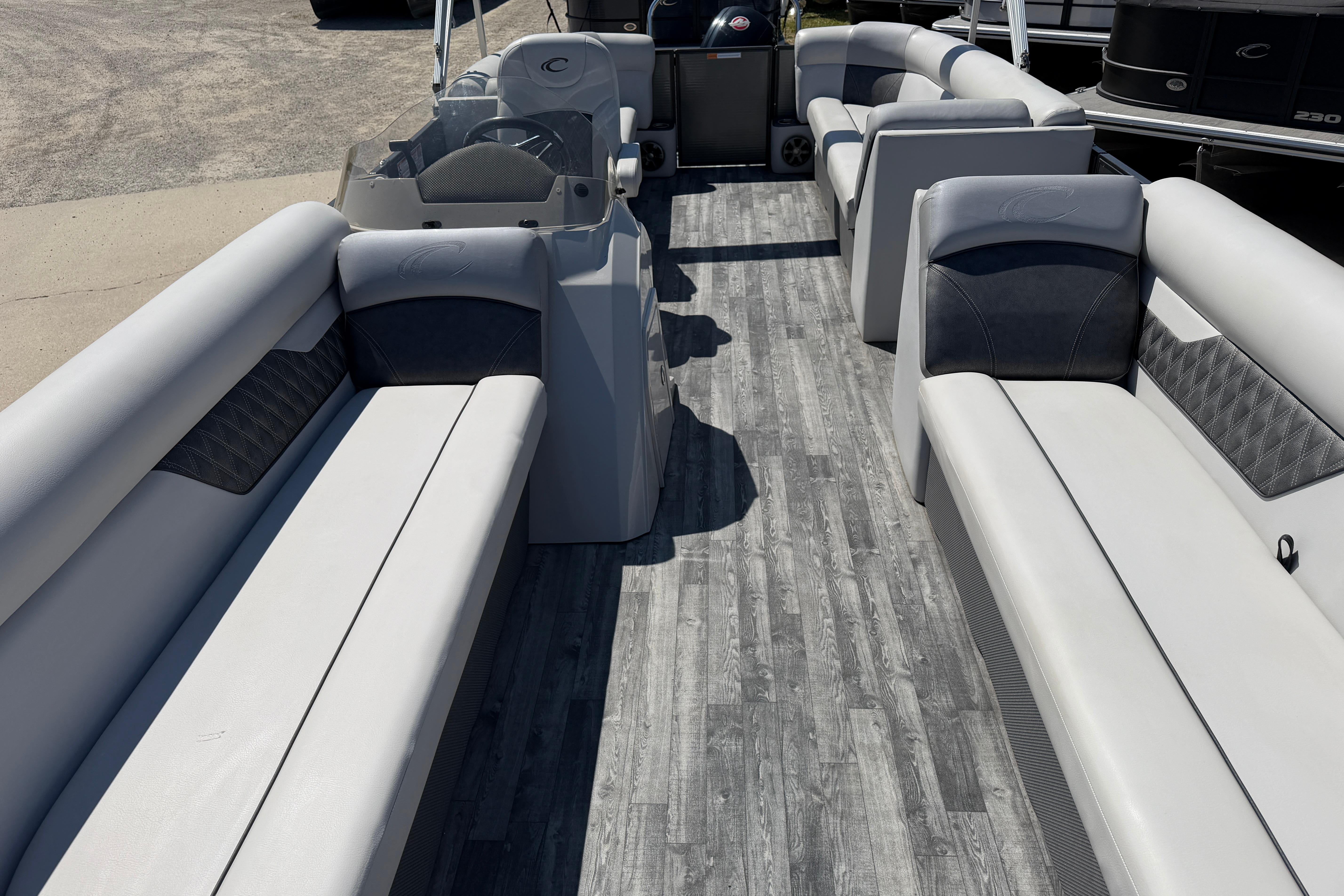 2019 Crest Classic DLX 240 SL pontoon boat interior with gray seating and wood-style flooring.