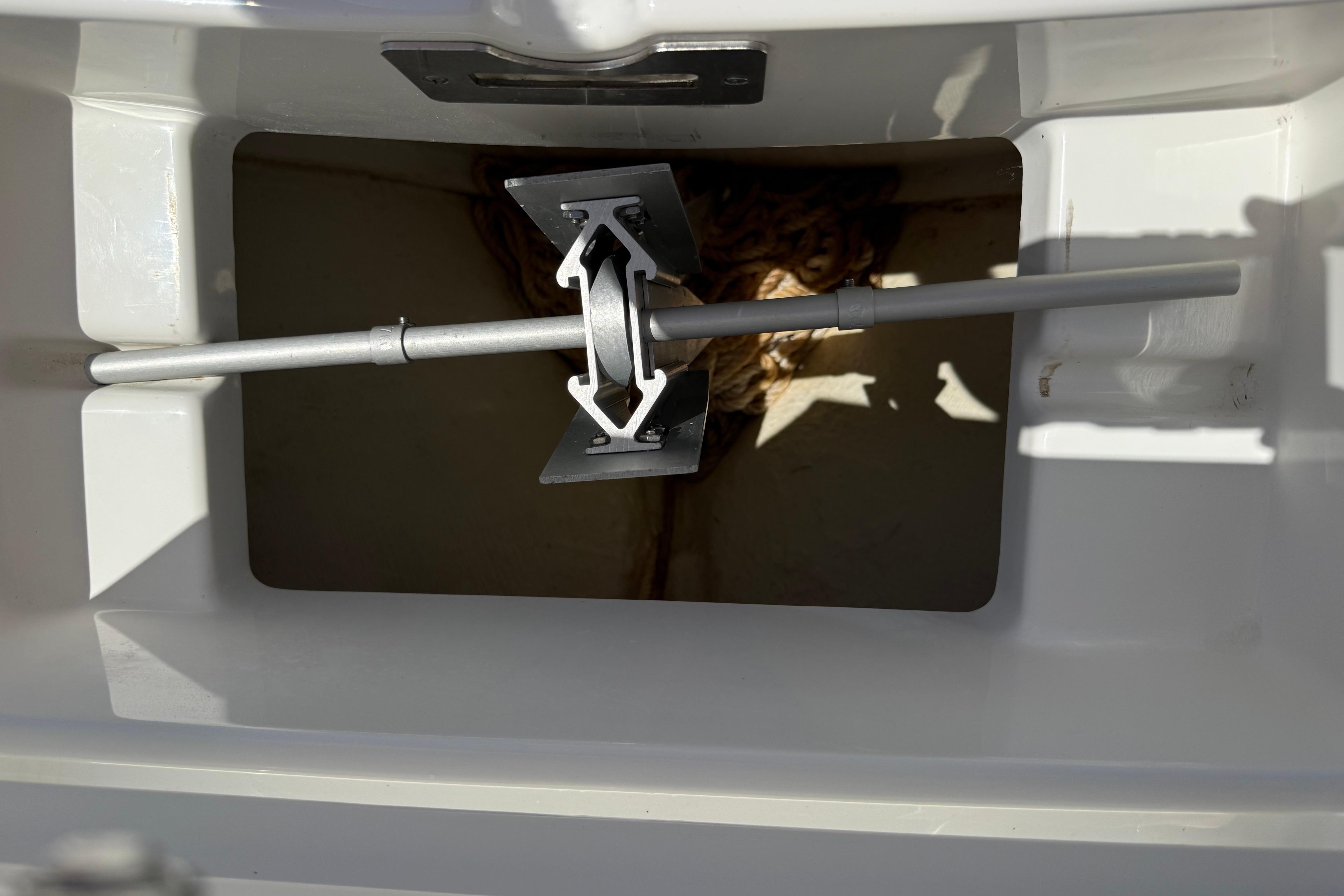 Anchor storage compartment on 2023 Regulator 26XO boat, featuring a neatly secured anchor.