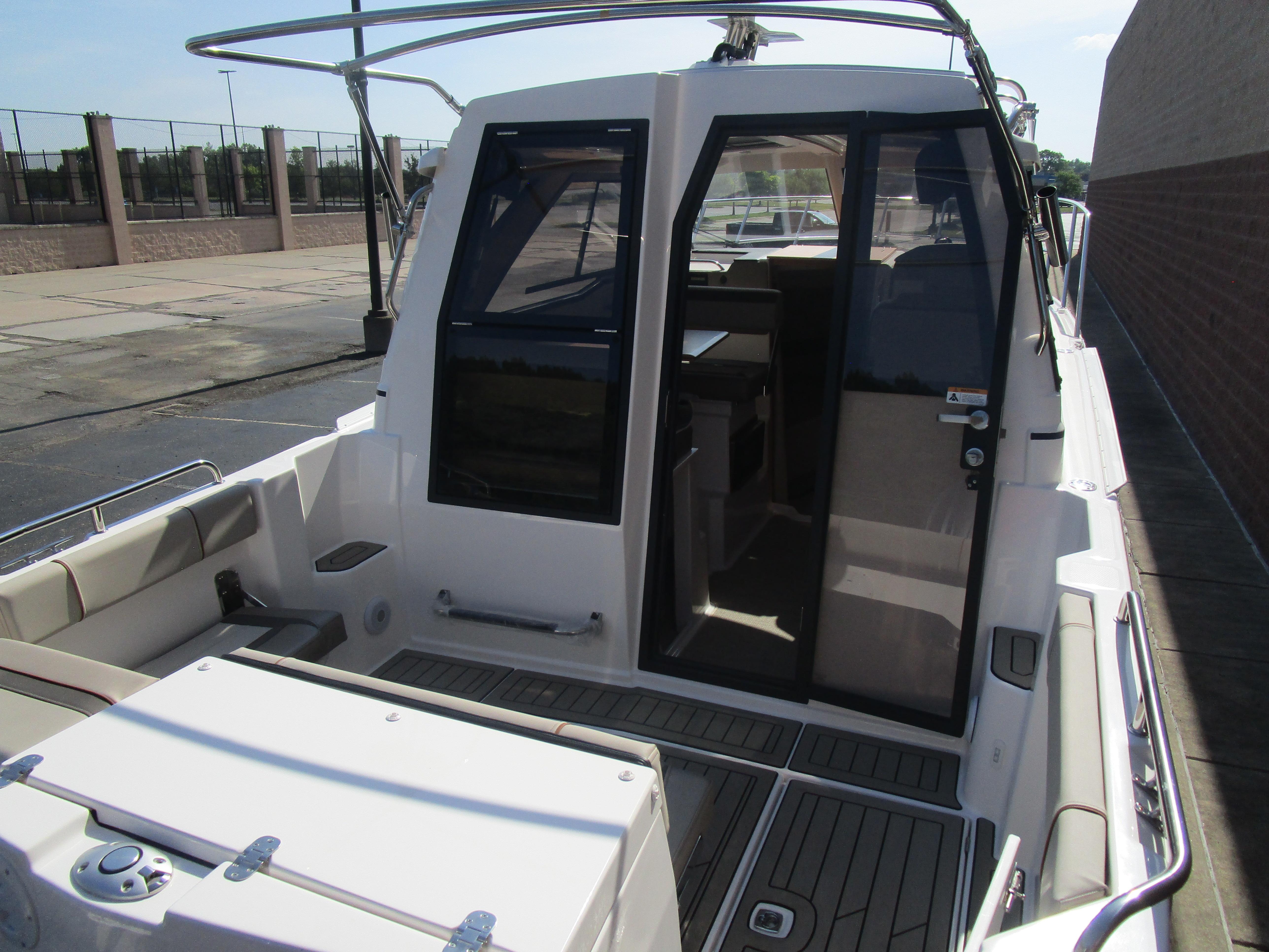 2025 Cutwater C-248 Coupe boat with open cabin door, docked outdoors.